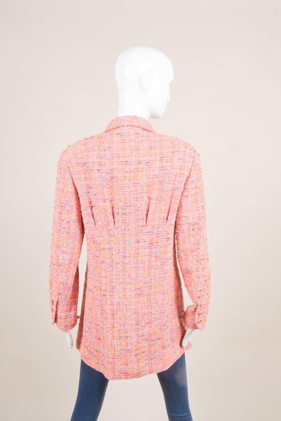 This lovely longline, fitted jacket is constructed of bright pink and multicolor, nubby confetti tweed material. Narrow shawl collar. Small, subtle pleats at chest and upper back Long sleeves. Front button fastening. Patch chest pockets and hidden