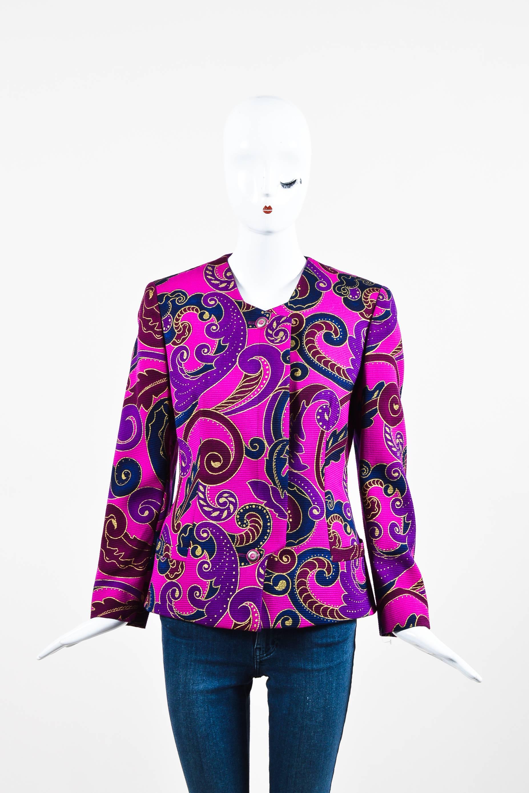Fuchsia wool jacket is printed with swirl and paisley inspired designs .Long sleeves have lightly padded shoulders .Lightly textured material .Hidden button closure down front .Pockets on front are basted closed .Lined throughout.

Additional