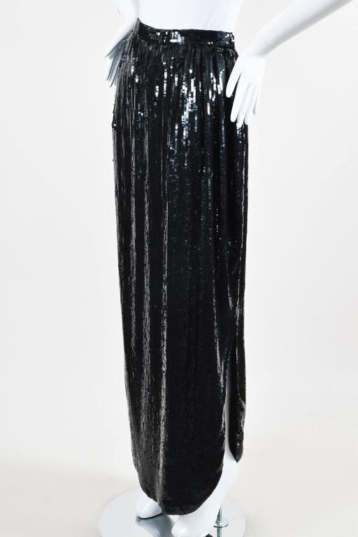 Sleek, long column skirt. Lustrous black sequins throughout exterior curved hem. Side slit. Back zip and hook-and-eye closure. Lined.

Additional Measurements: Slit length: Approximately 20"