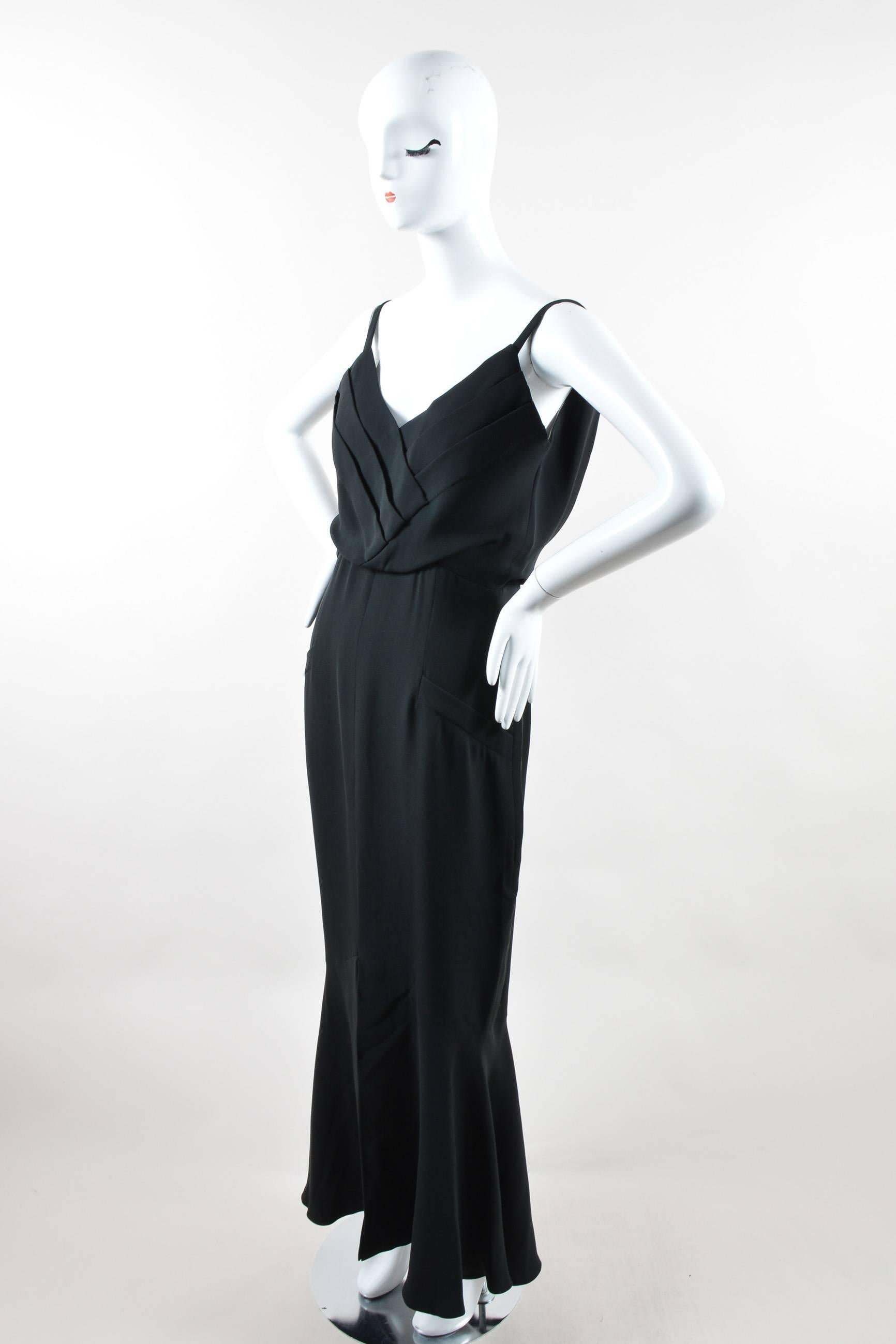 Elegant and understated, this is the perfect dress for any formal occasion. Constructed of silk crepe. Pleated blouson bodice. Sleeveless. The straps at front are concealed in the back. Straight skirt flares at bottom. Faux, slanted welt pockets at