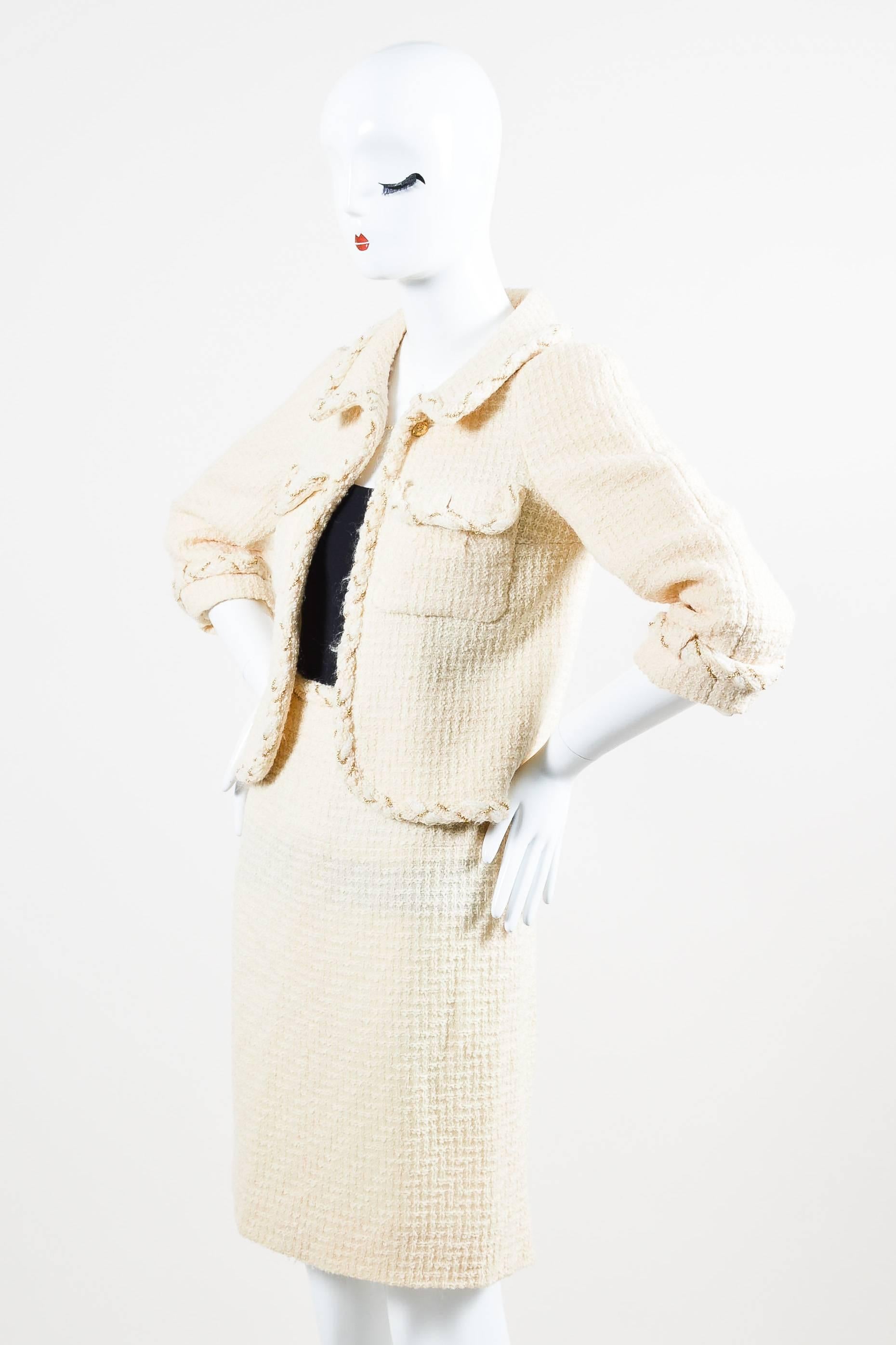 Two piece set comes with matching cream tweed jacket and pencil skirt. Jacket has two button flap pockets on front and cropped sleeves. Single pull through button closure below the collar. Pencil skirt has two buttons in back that can be used to