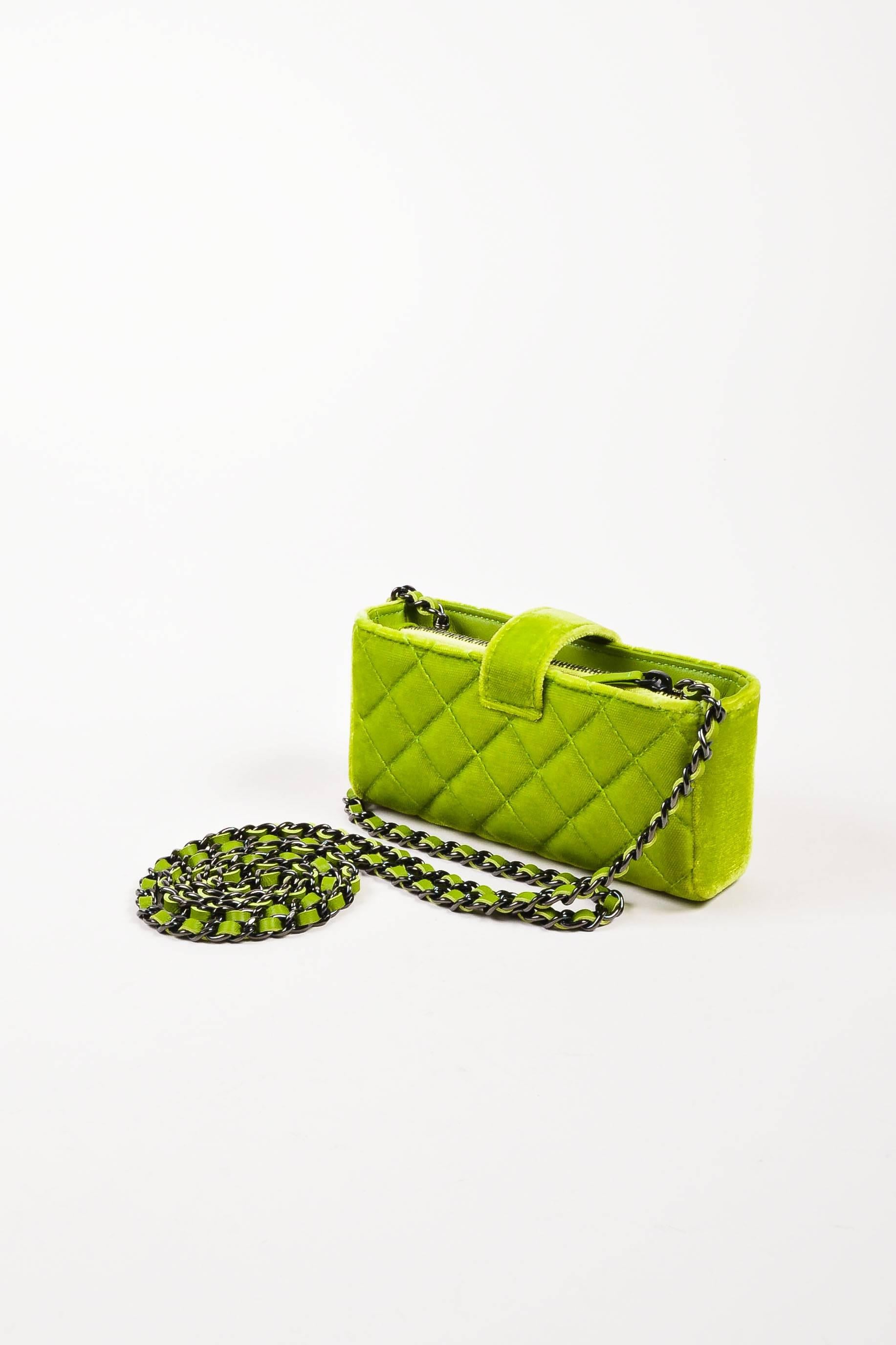 Circa 2015. Add a pop of color to your look with this chic and fun mini bag. Constructed of plush velvet in an electric lime green shade. Signature Chanel diamond quilting throughout. Gunmetal hardware, including 'CC' logo on top snap tab. Chain