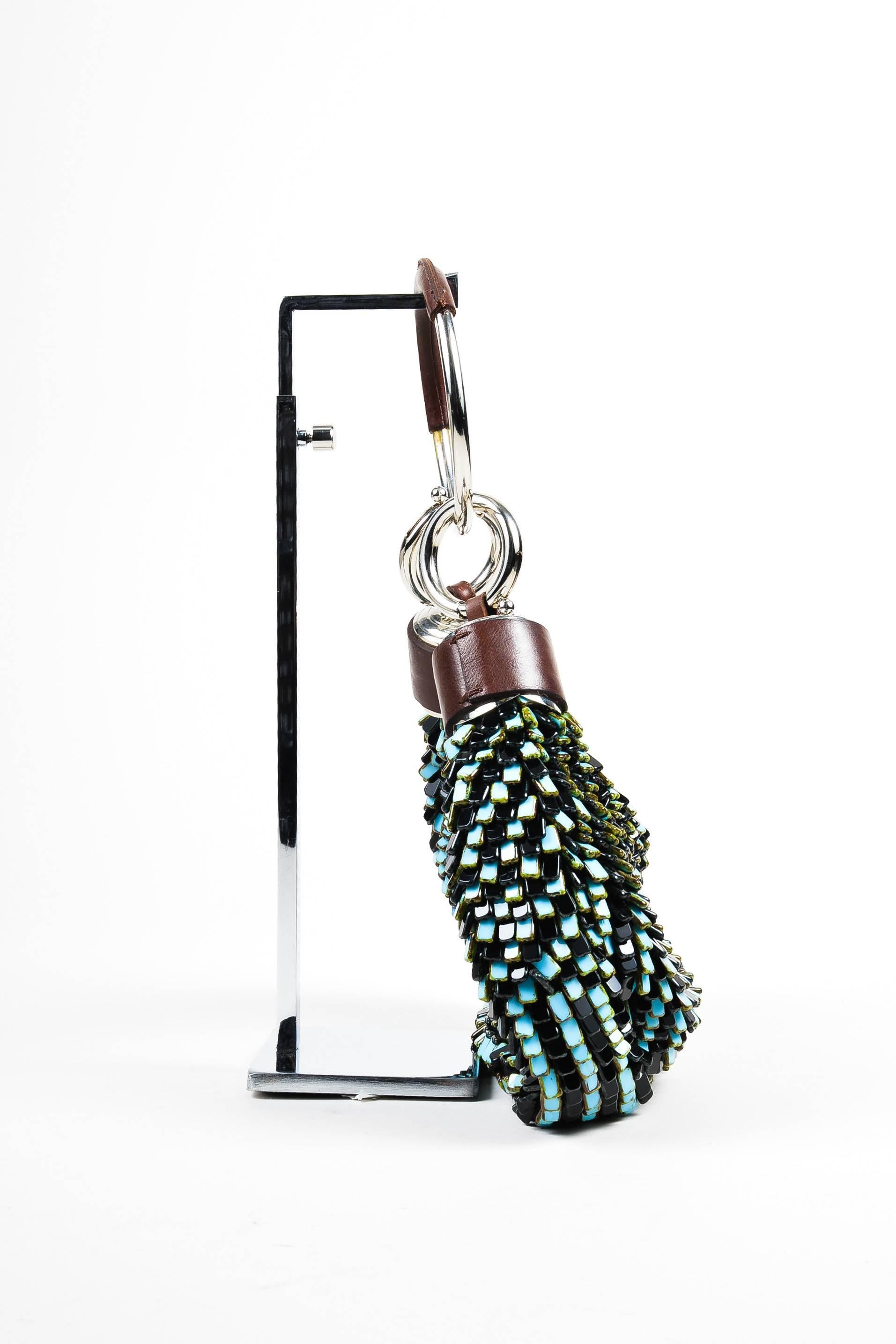 Chloe brown turquoise leather heavily beaded bracelet miniature hobo bag. Features silver-tone metal ring handle with brown leather trim. Zip top opening. Great accent piece. Lined. Comes with dust bag. Model/serial #: SC-33-02-06-54.

Additional