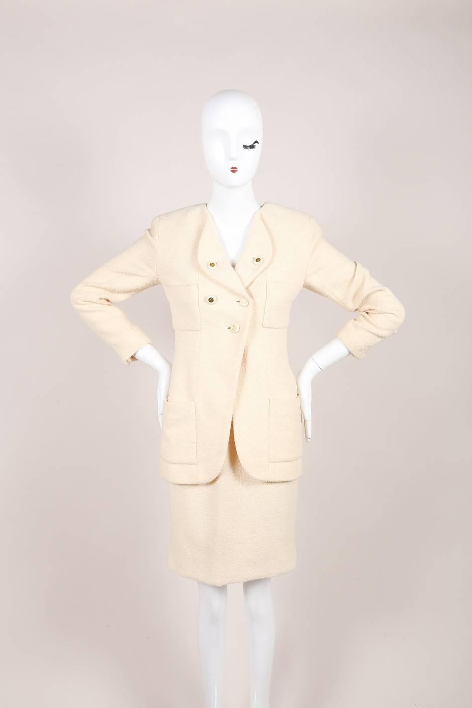 Classic and chic Chanel vintage skirt suit from the Chanel 1994 Spring Collection. Jacket: Cream tweed wool blend. Long sleeves with gold tone ‘CC’ button closures. Folded lapel with gold tone ‘CC’ button closure. Square pockets at bust and hips.