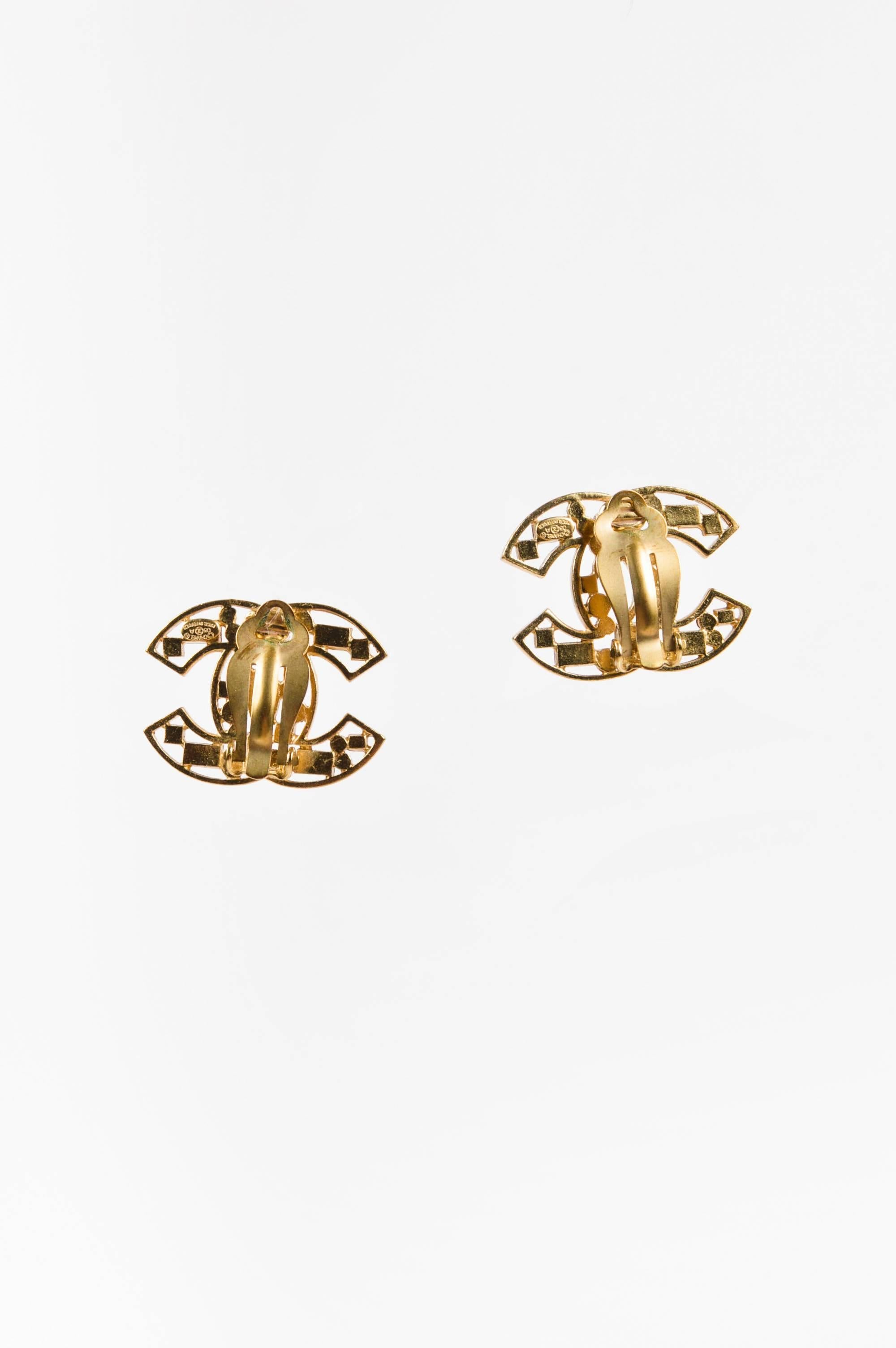 Earrings form the fall 2003 collection for everyday sophistication. Gold-tone metal construction. 'CC' shaped base with cut out detail. Mixed colored crystal embellishment. Back hinge clip-on closure.

Additional Measurements:
Total Height: 23