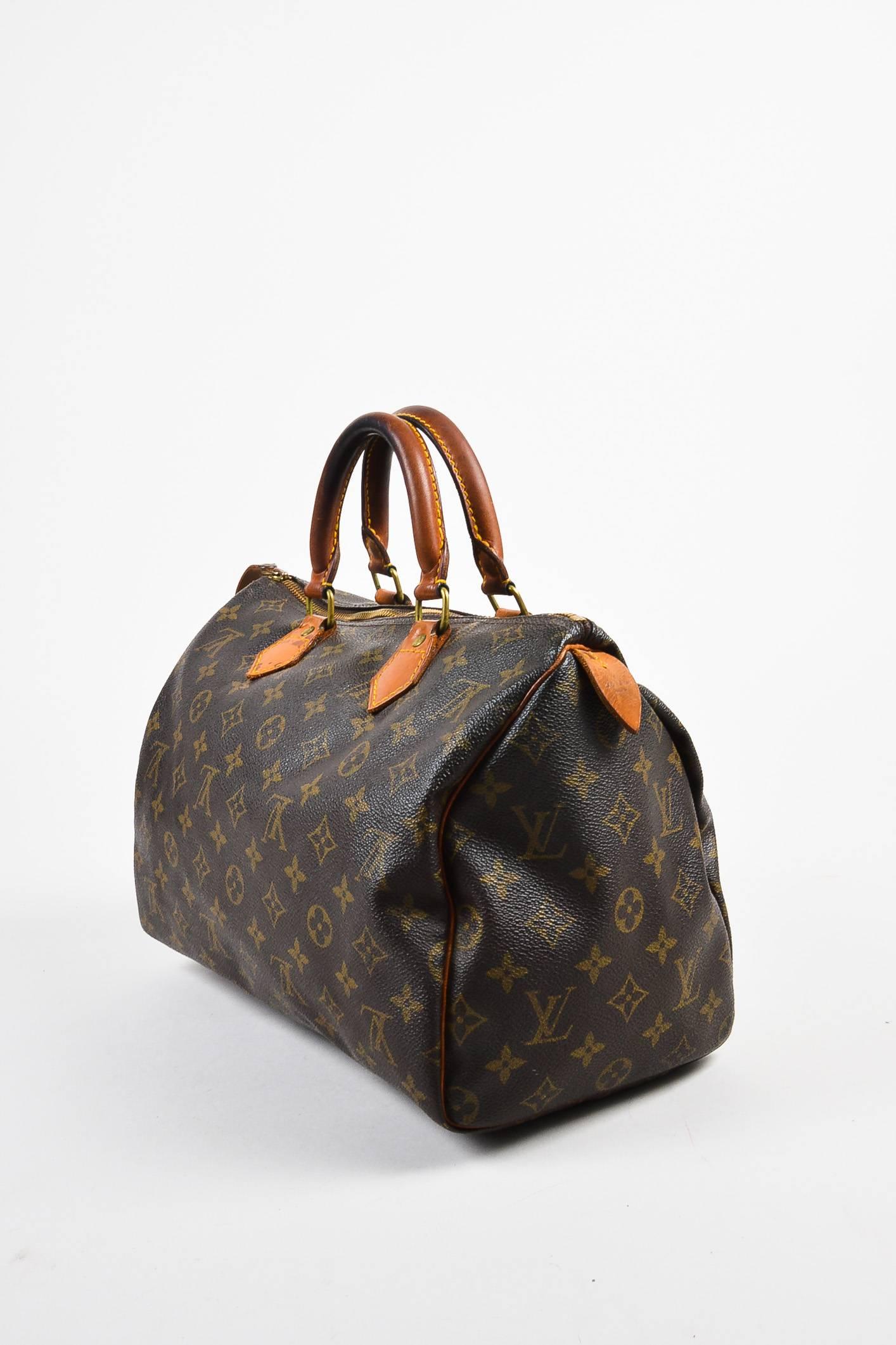 Comes in dust bag. Vintage Louis Vuitton 30cm size "Speedy" bag comes in classic monogram canvas with leather trim. Two rolled top handles. Zipper closure. Lock is attached at side but keys are not included. Date code reads,