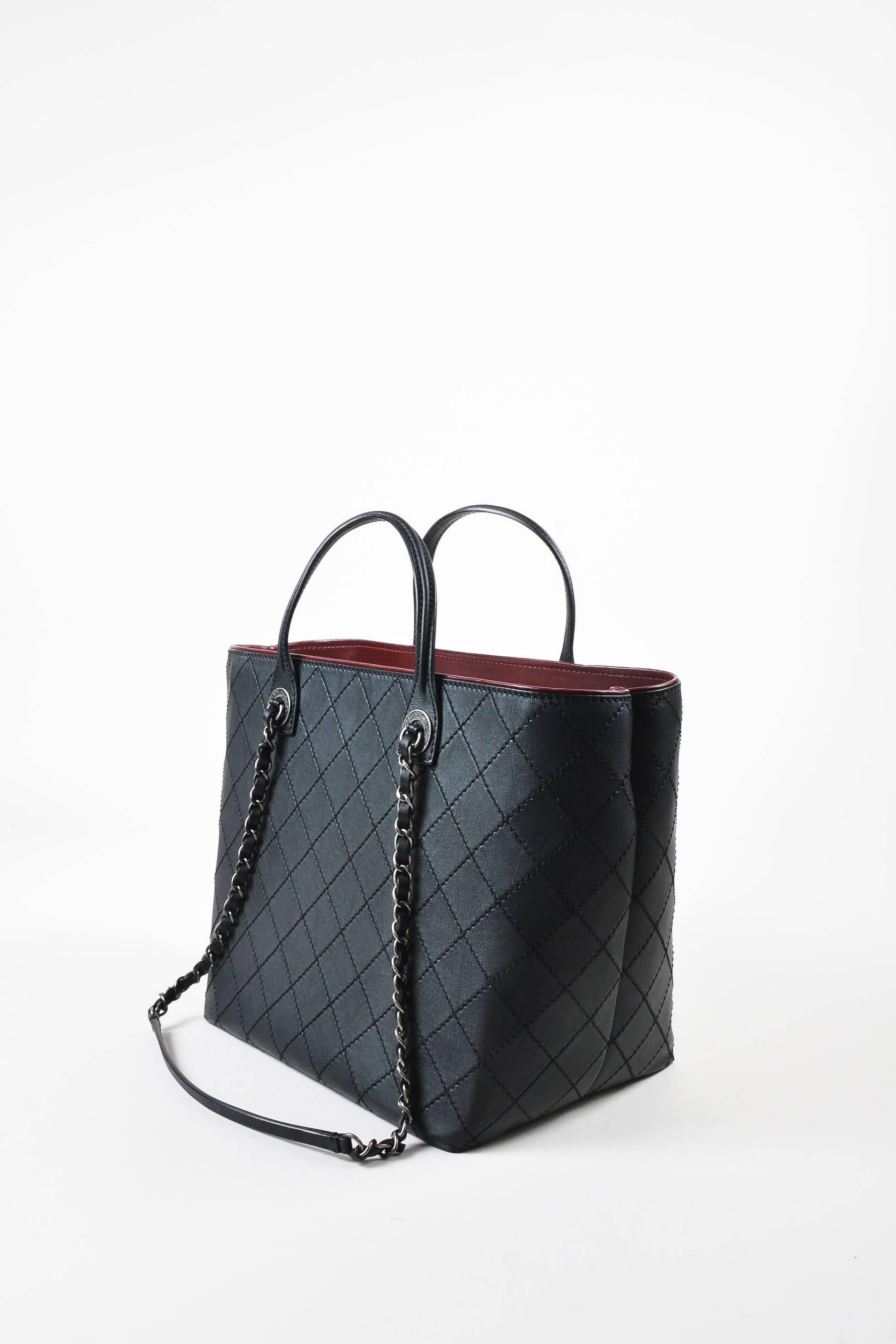 Retails at $3800. Supple, smooth black leather shopping tote bag from Chanel's 2016 Cruise Collection. Signature diamond quilted stitching throughout. Bag can be worn on hand with the two top handles or on shoulder with the longer chain straps.