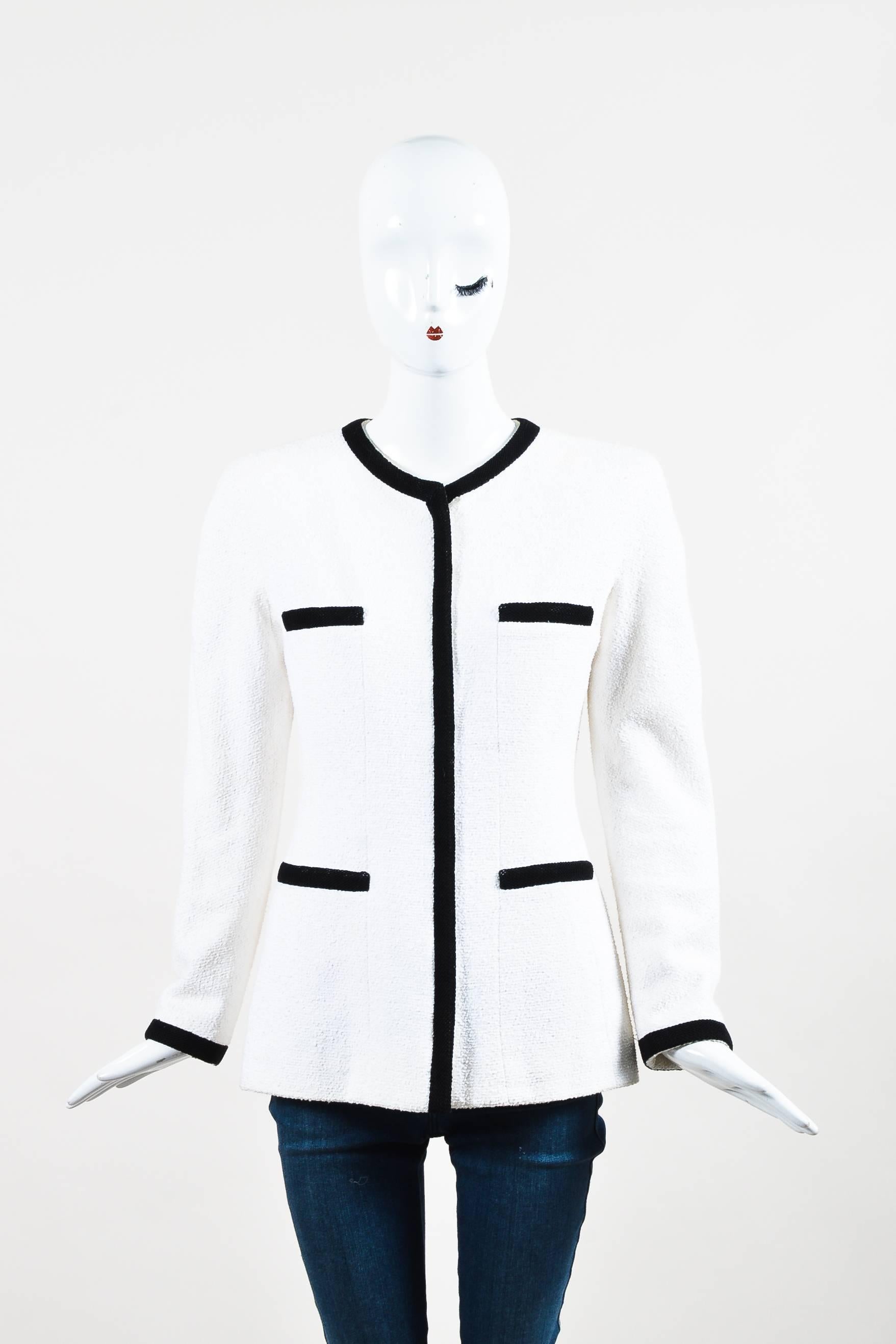 This must-have jacket features a trendy color-block design in a classic combination, elegantly structured shoulders, a woven trim at the neck, sleeve hems, and down the front, four front pockets, and a concealed zipped front. Signature chain trim