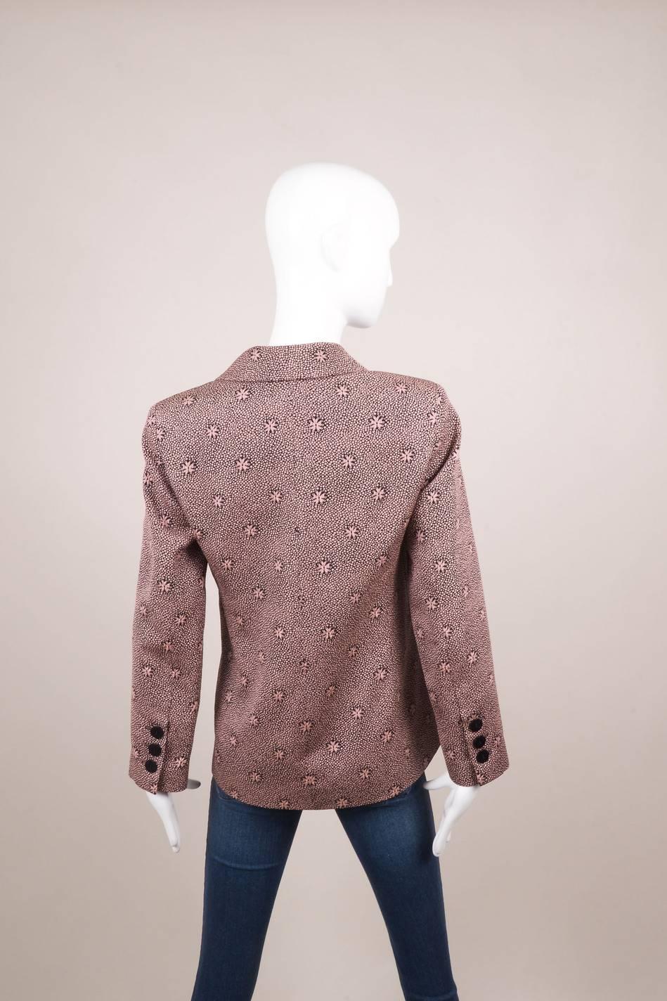 This long sleeved jacket features a star burst and dot print detail throughout with peak lapels.and a front double breasted button closure. Front slit pockets. Button detail on sleeves. Padded shoulders. Lined.

Additional Measurements:
Sleeve