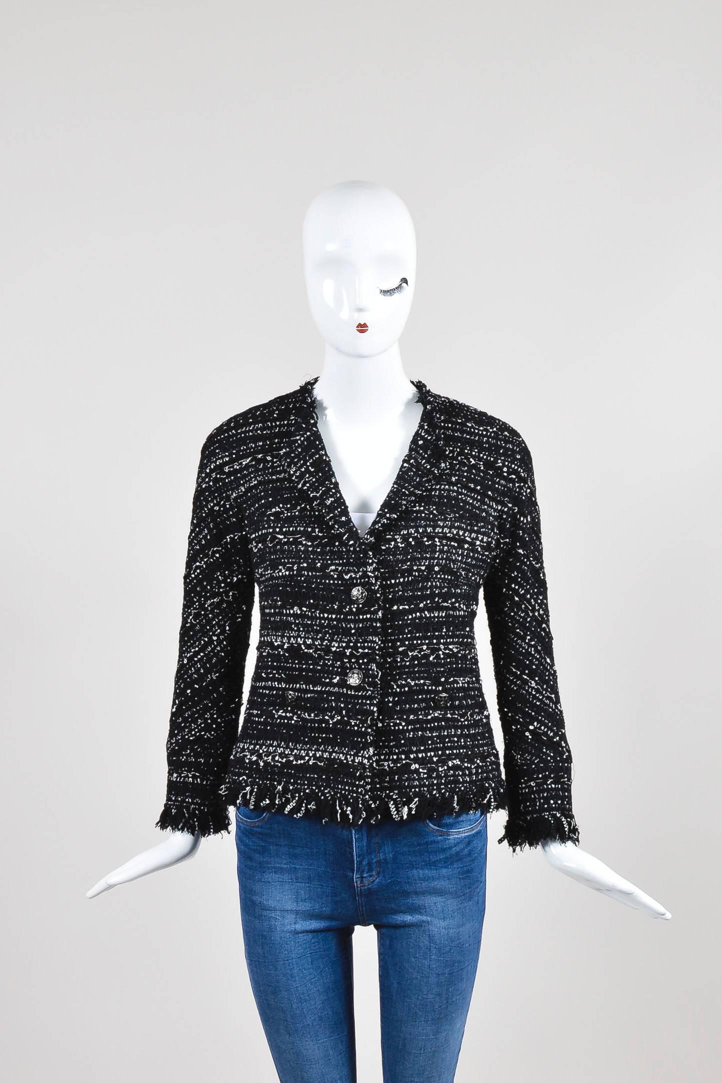 French house Chanel is known for their beautiful classic tweed jackets and this gorgeous piece is no exception. Black and white in color with bracelet length sleeves and two front pockets with Chanel logo embellished lacquered buttons. This item