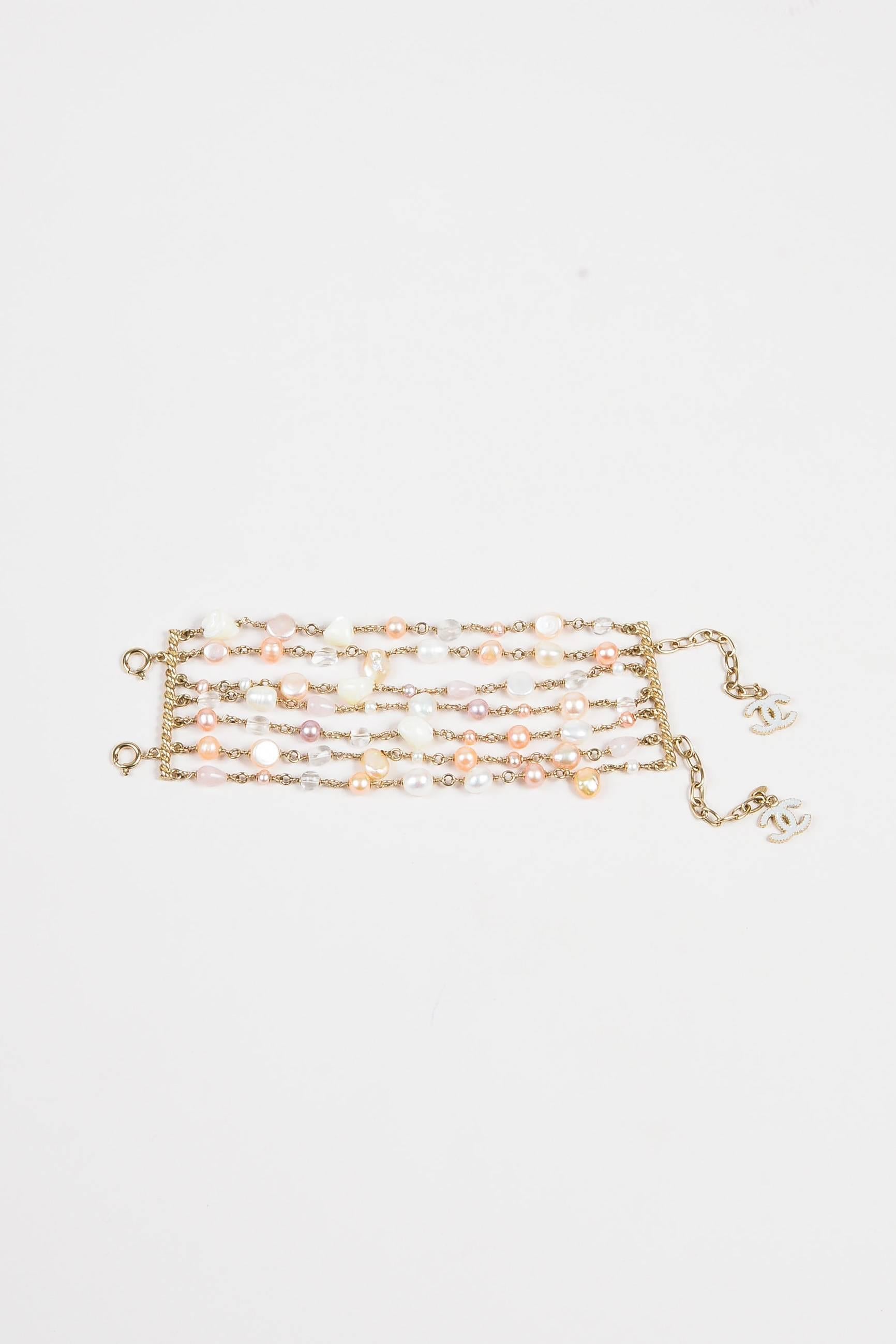 Retails at $2320. Luxuriously construction bracelet to add feminine statement to any look. From the spring 2012 collection. Gold-tone plated metal. Seven link strands with pastel colored faux pearls and glass beads. Links are attached to bars with