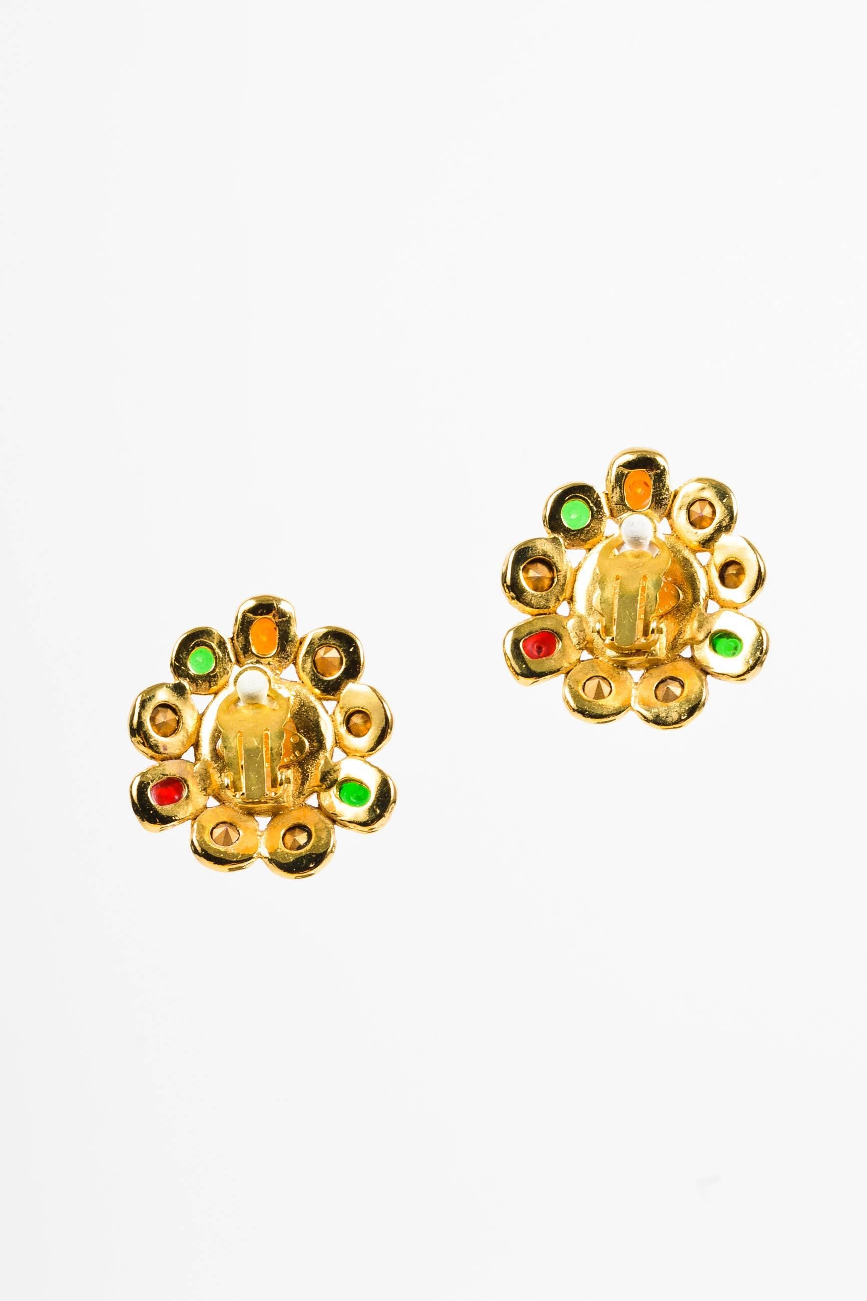 Comes with box. Beautiful Chanel statement costume earrings from season 26, circa 1989. Multicolor gripoix stones and shimmering rhinestones encircle a faux pearl centerpiece. Gold-tone metal. Hinge clip on closure with pad.

Additional