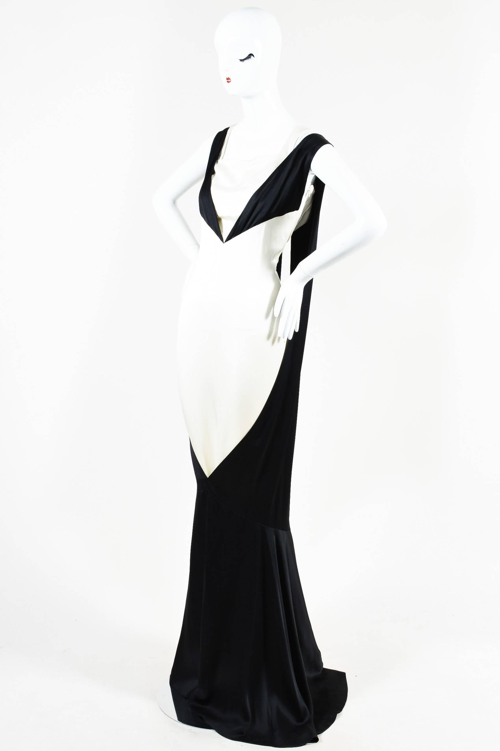 A statement on its own, this stunning Parisian-chic gown rendered in luxurious silk features a unique design and silhouette. Detailed with an open back/front, dual split overlay, this dress features a trendy color-block design, layered straps, and a