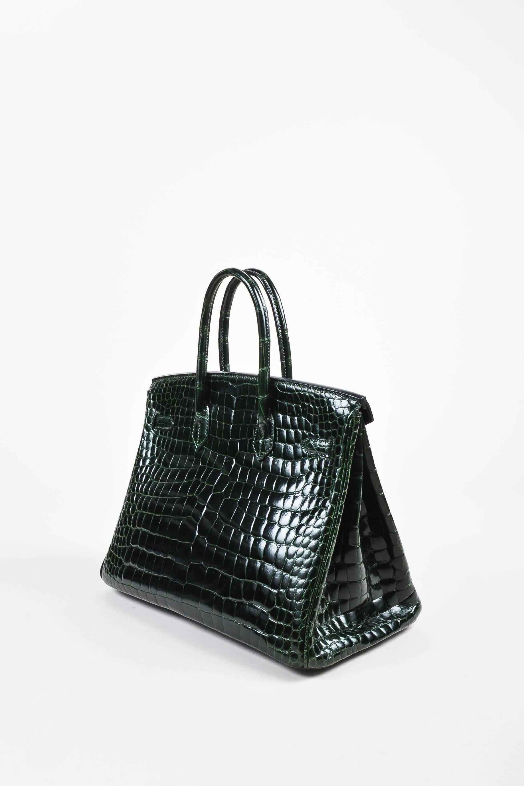 One of the most recognizable pieces amongst celebrities and fashion insiders alike--this 35 cm "Birkin" bag, from the French house Hermes, is an iconic collectible handcrafted in Paris. Masterfully constructed of shiny Porosus Crocodile
