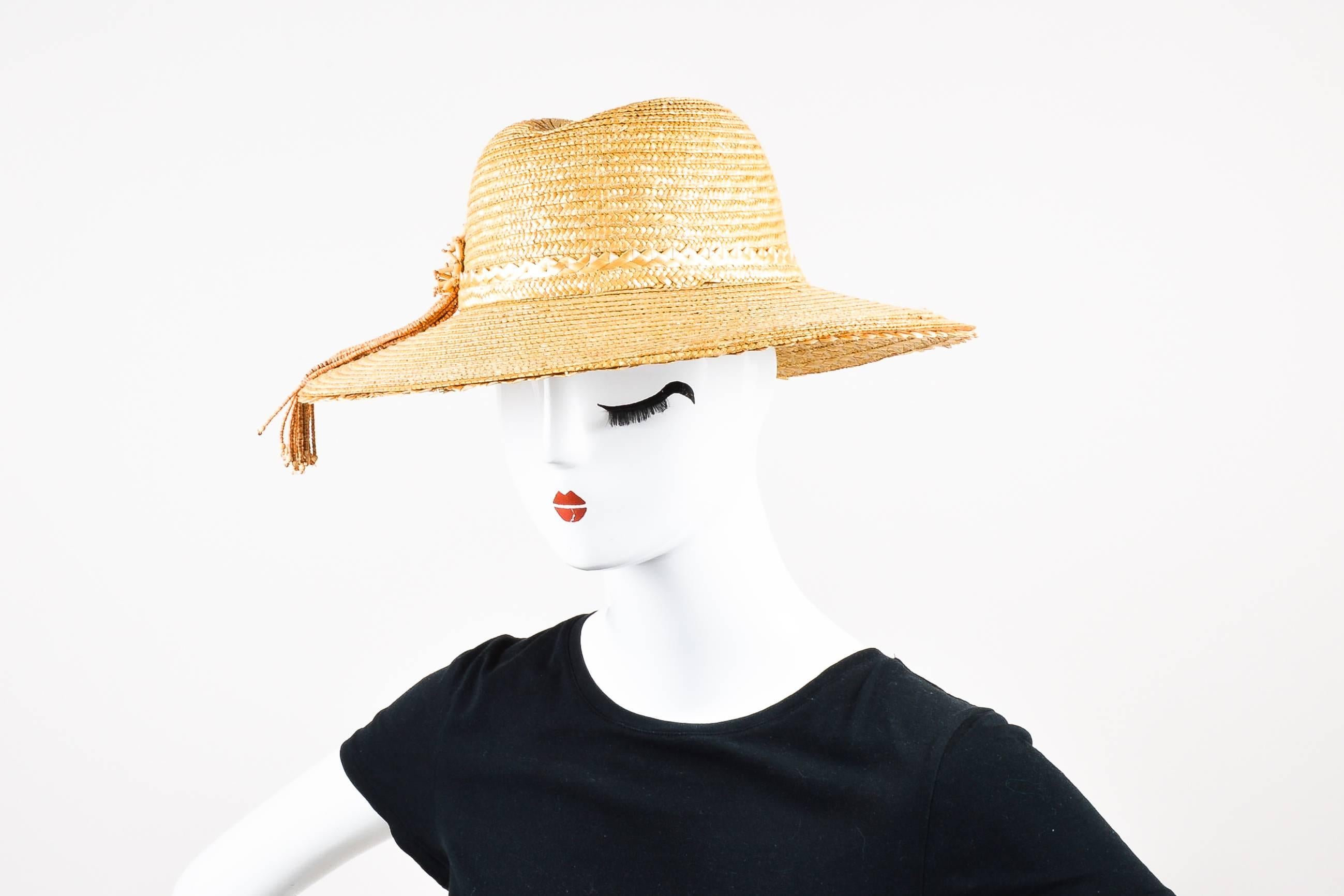 Golden yellow woven straw hat. Tan wood bead fringe details.

Fabric Content: 100% Straw

Measurements:
Total Width: 14.5