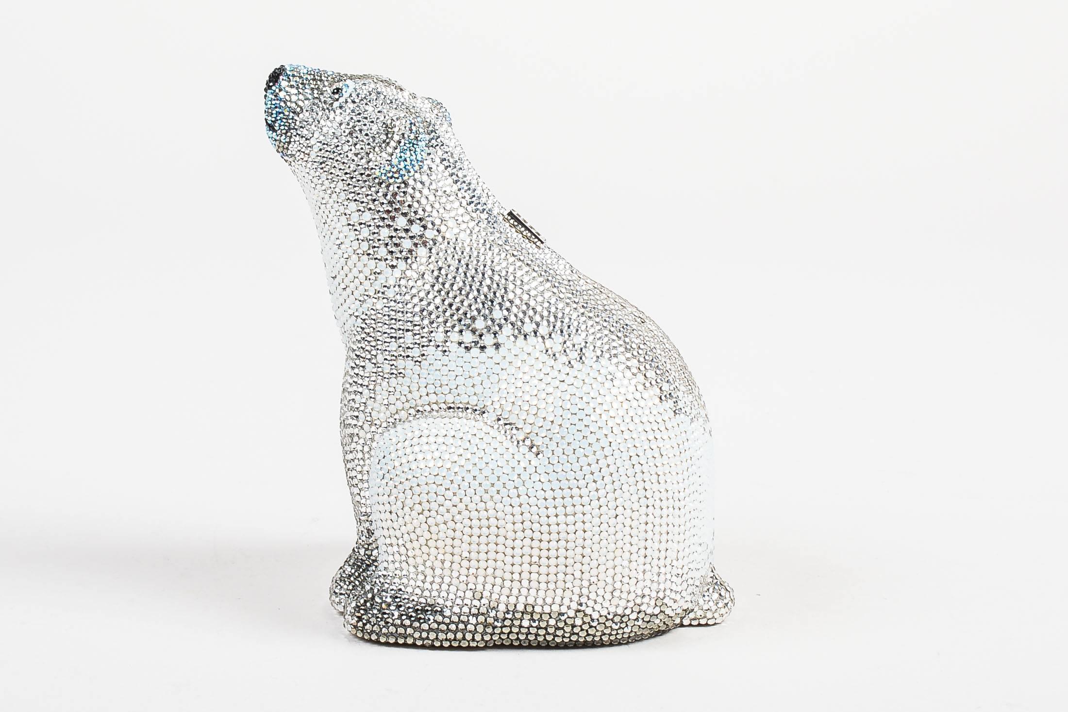 Judith Leiber Couture silver polar bear clutch adorned with rhinestone crystals. Features a push button clasp closure and silver-tone metal base. Comes in box with dust bag, an optional chain strap, coin purse, and small mirror. Lined with