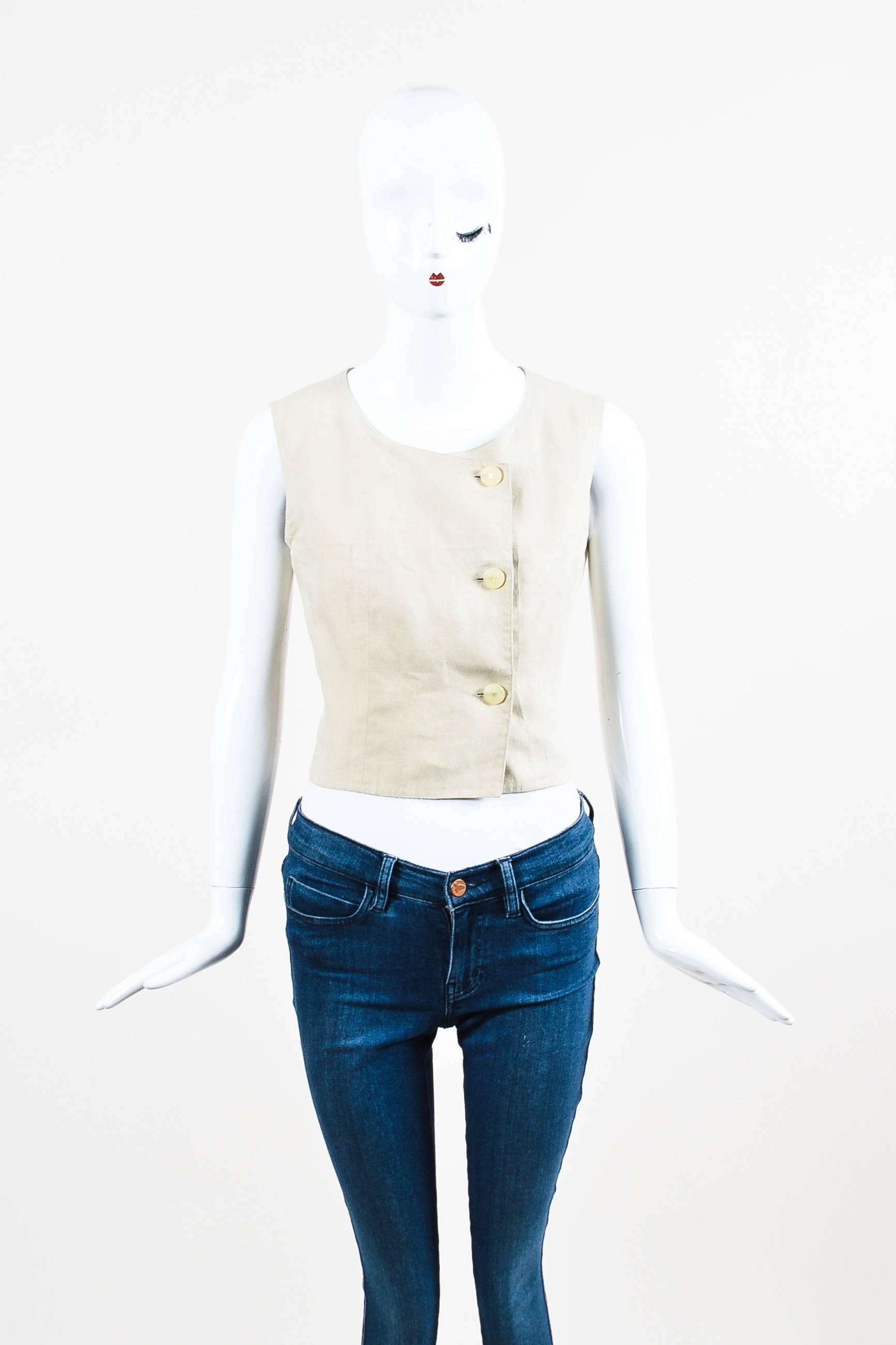 Minimalist vest featuring an asymmetrical front with 'CC' translucent buttons and a scoop neck. Unlined.

Size	
40 (FR)
8 (US) 	 	

Additional measurement: Shoulder -to- Shoulder 13.75