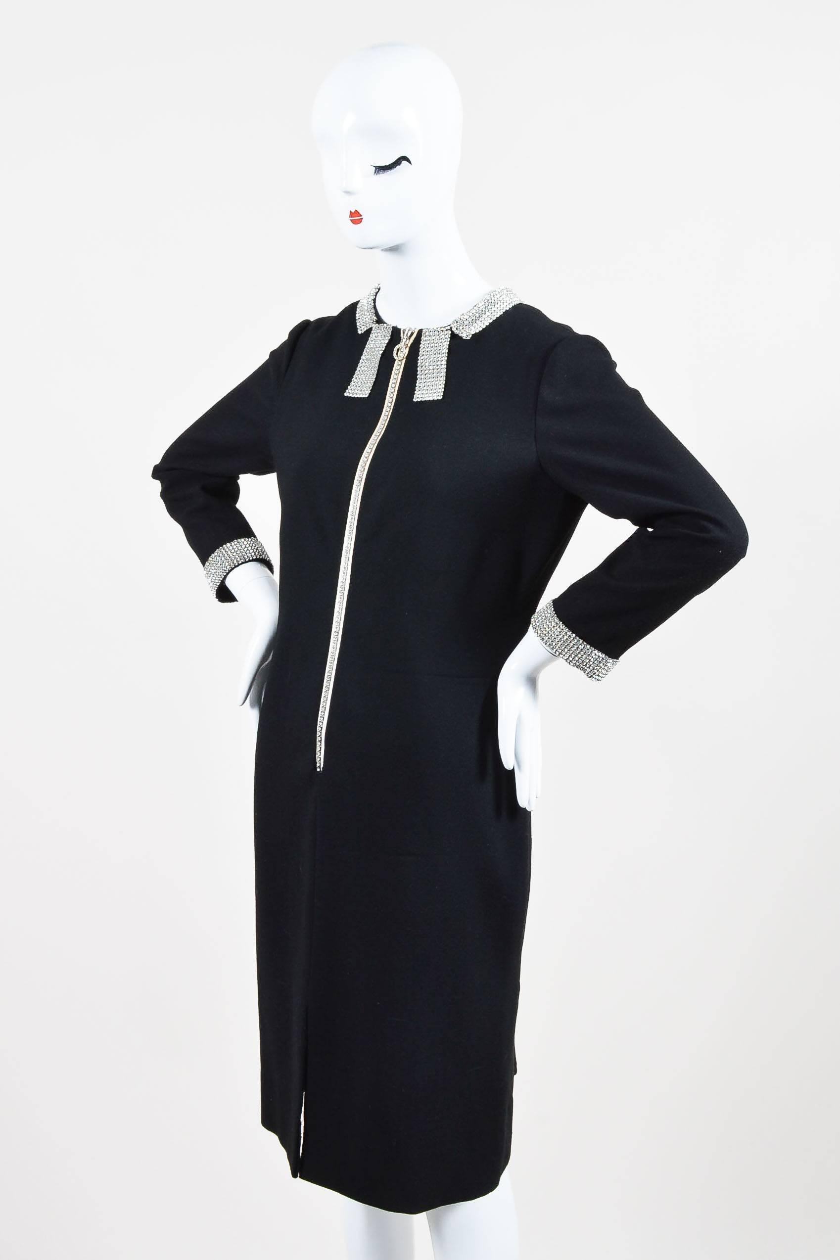 Elegant zip-up dress constructed of black crepe features sparkling rhinestone embellishment at collar, zipper, and sleeve cuffs. 3/4 length sleeves. Straight silhouette. Rounded neckline. Lined.

Additional measurements: Sleeve Length 20.25