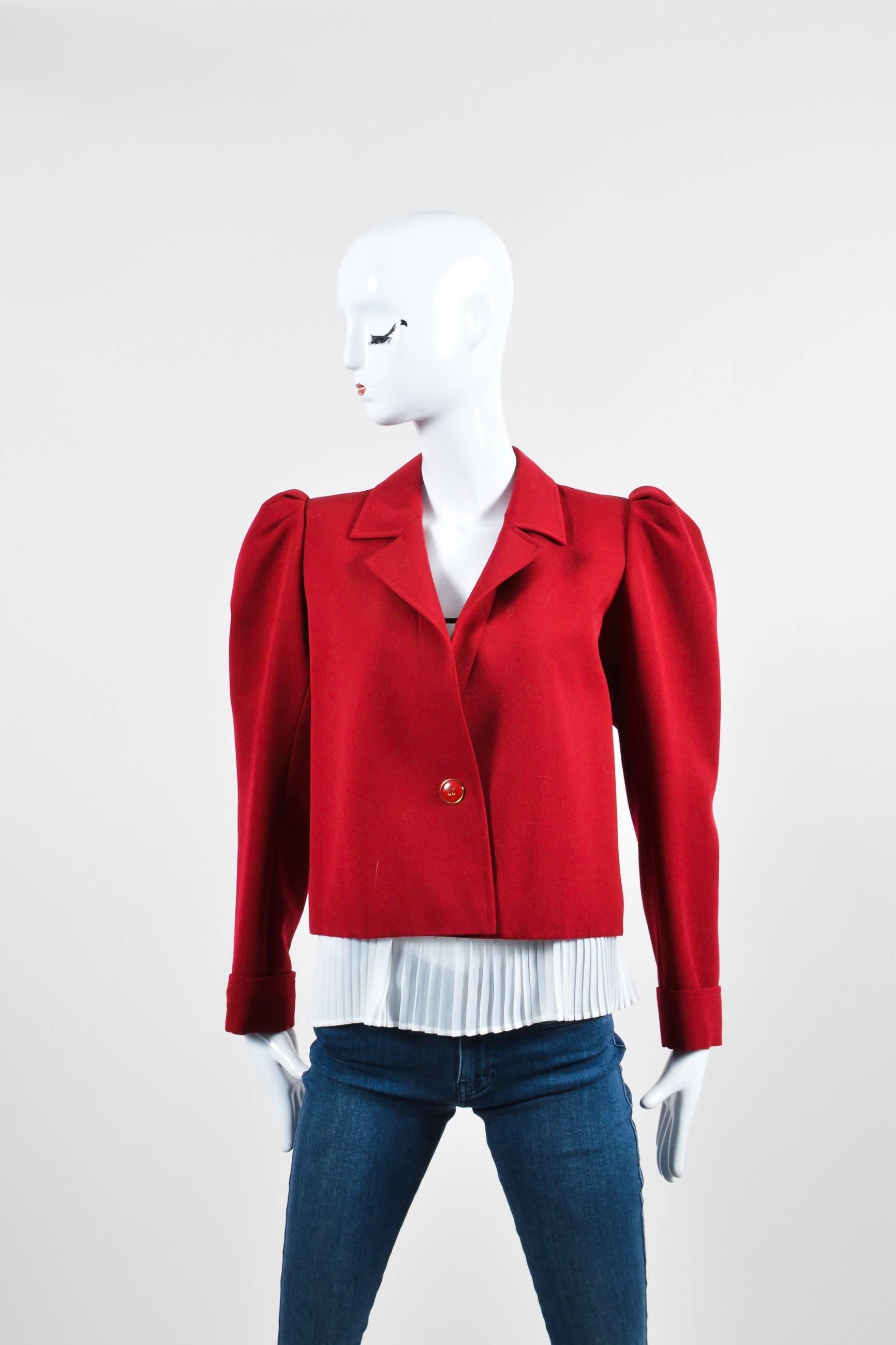 Vintage Saint Laurent Rive Gauche jacket in red wool. Features a notch lapel and leg-of-mutton cuffed sleeves. Red and gold-tone buttons underneath cuffs and a single buttn closure at waist. Hits at lower waist. Fully lined. Pair this stunning piece