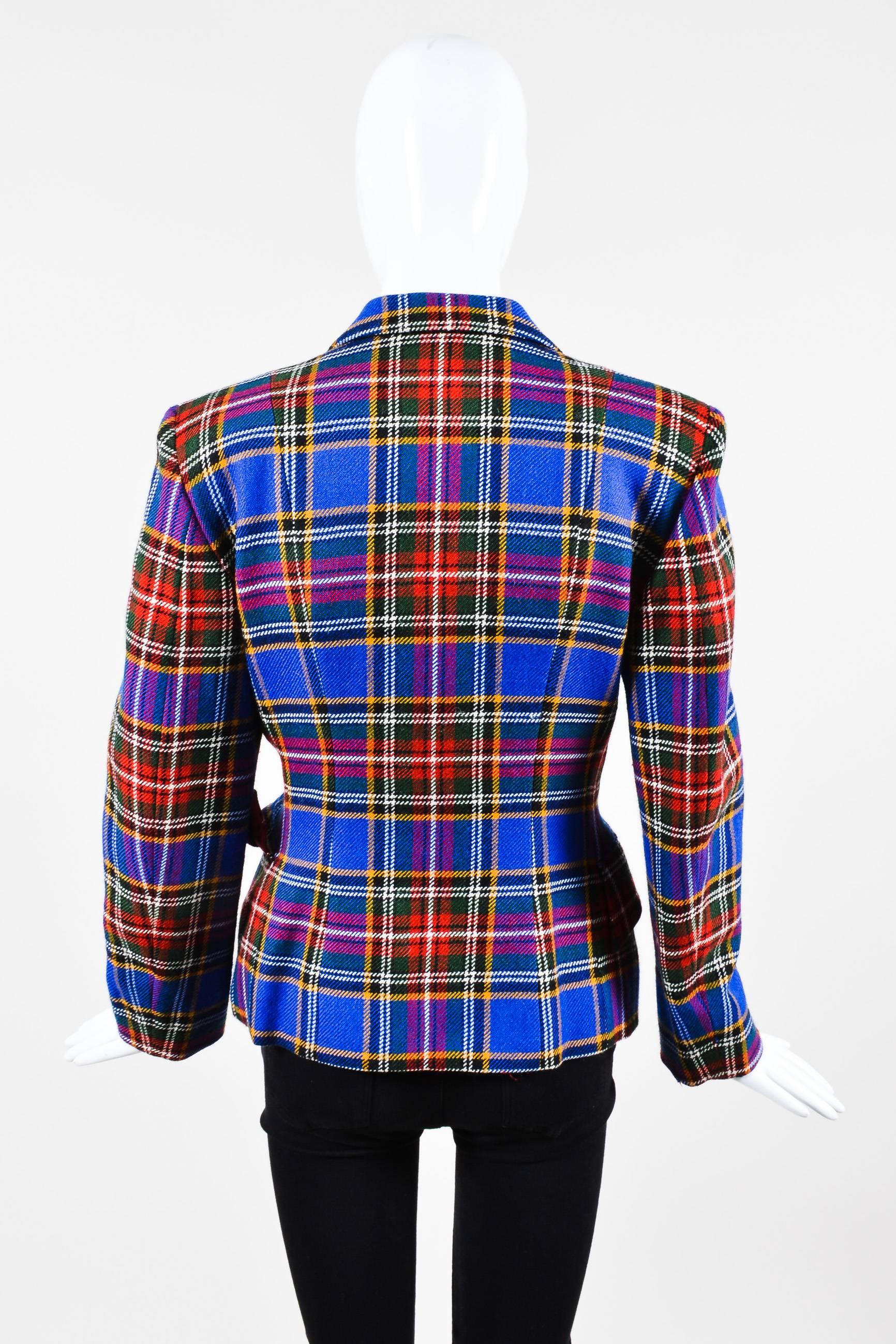 Uniquely chic vintage jacket perfect for work, an event or a casual day out. Wool textile. Multicolor plaid pattern throughout. Whimsical front bath tub knob embellishment. Peak lapel collar. Hits at hips. Long sleeve. Side flap pockets. Padded