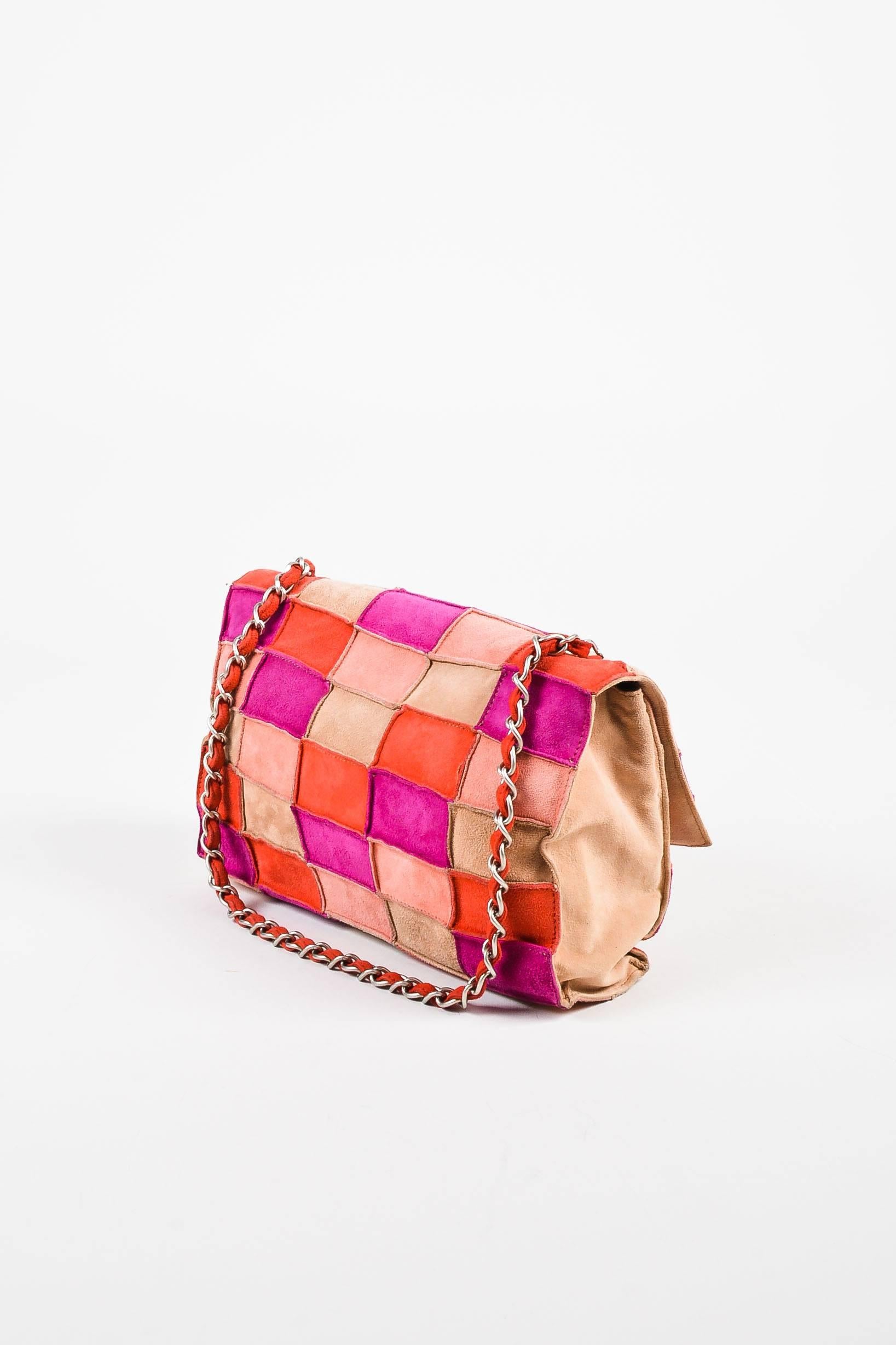 Soft brushed suede leather construction. Silver-tone hardware. Multicolored patchwork panels. Chain strap with leather woven throughout. Front flap with classic 