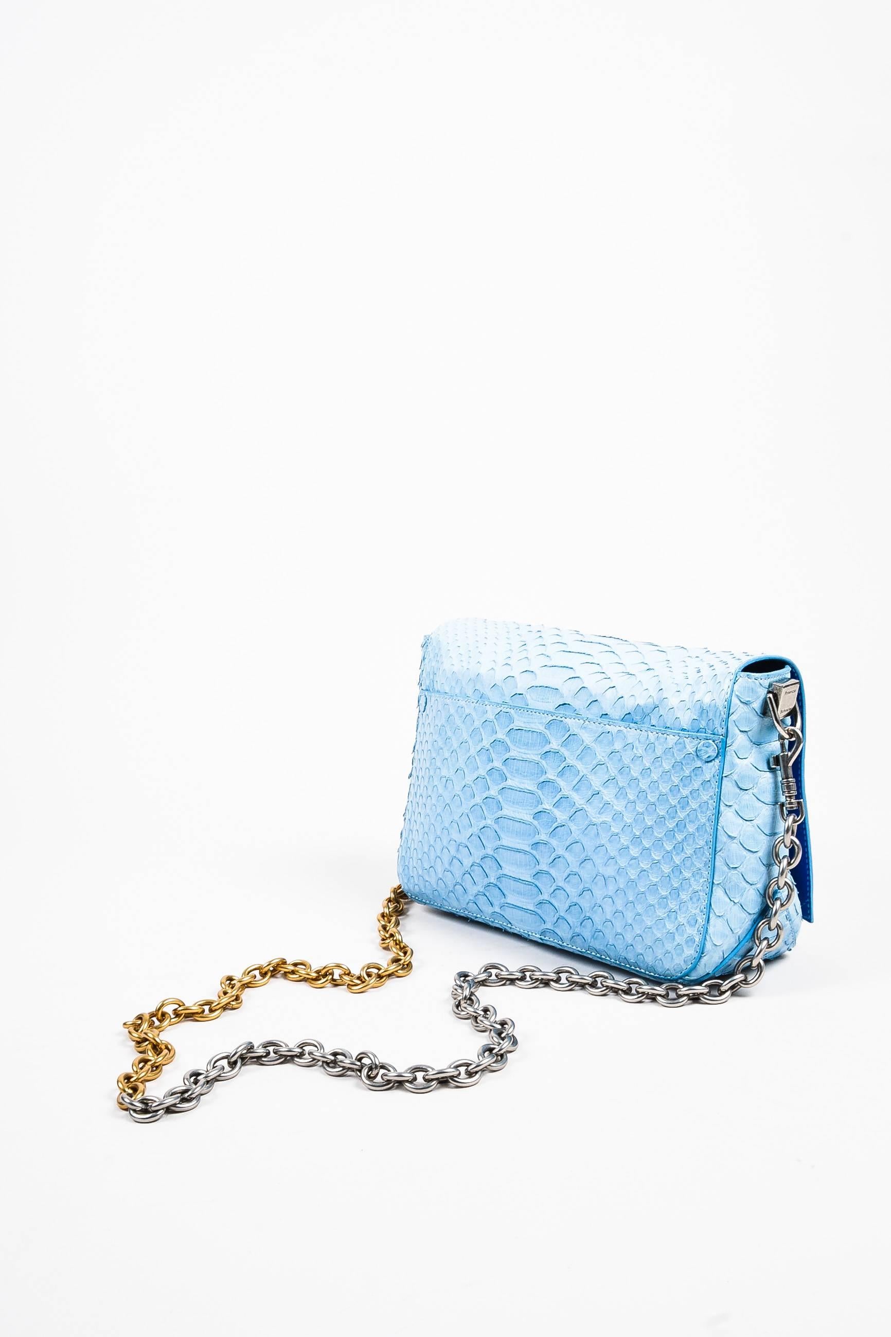 Sky blue python "Small Courier" crossbody bag from Proenza Schouler. Unique two-toned silver and gold chain link shoulder strap. Flap with hinged flip lock closure. Royal blue leather lining. RFID tag:1000067833.

Additional notes: Small