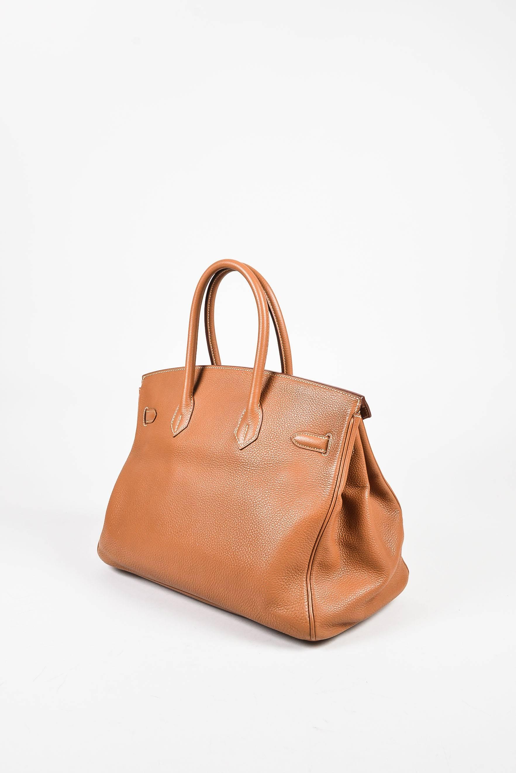 The timeless "Birkin" never goes out of style. This highly coveted tote is the perfect bag to carry your everyday essentials in classic sophistication. Supple clemence leather construction. Gold-tone hardware. Top rolled handles with