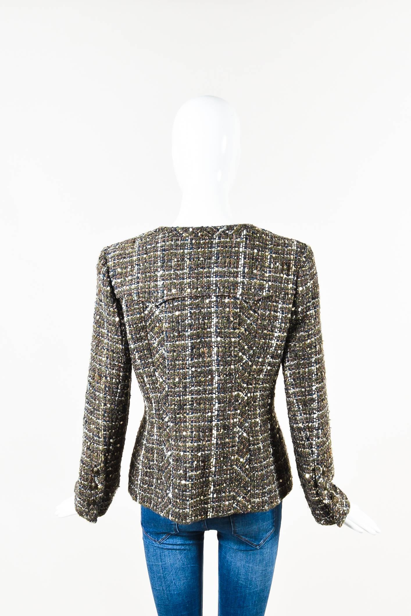 Olive green, brown, navy, white, and cream tweed open jacket from Chanel. Fabrication is unknown, but appears to be wool. Rounded neckline. Shoulder pads. Bronze tone decorative buttons. Two front faux flap pockets with button closures. Buttons on