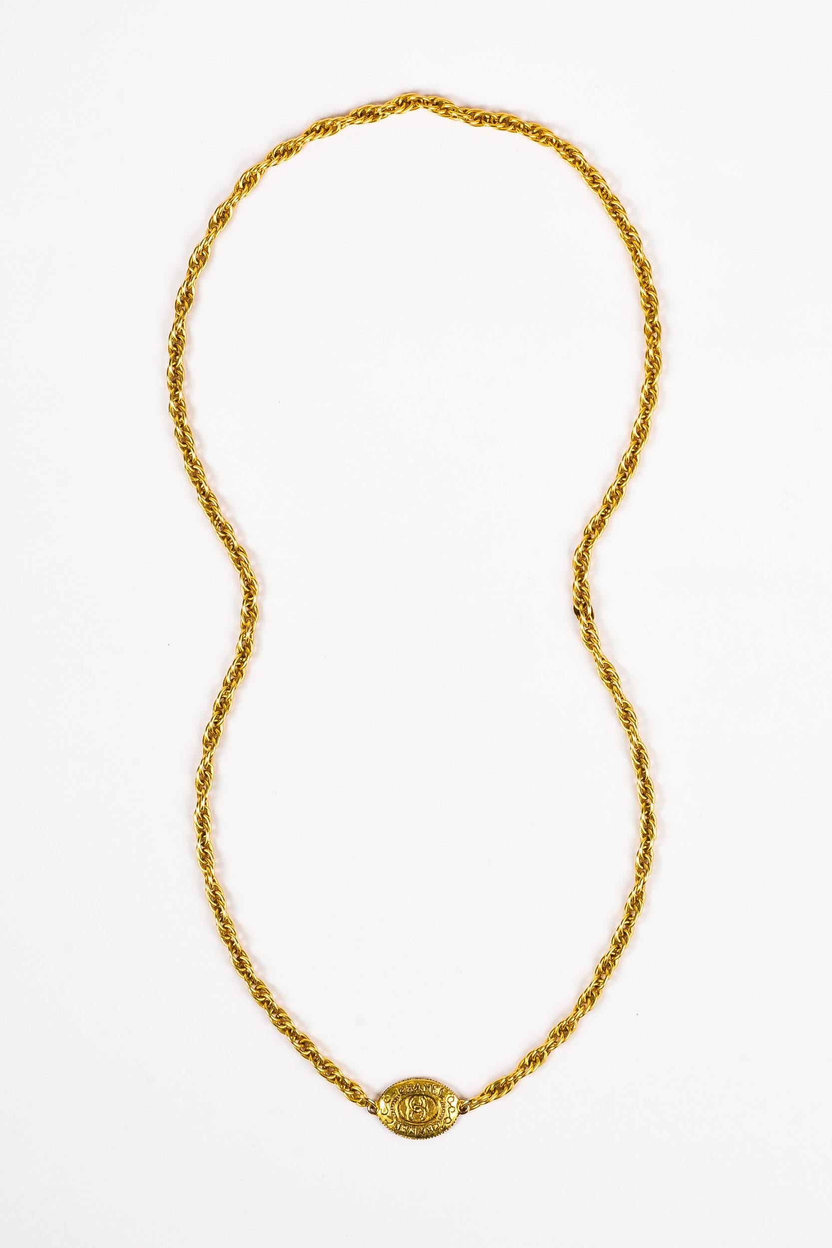 Simple, yet elegant vintage Chanel chain necklace from the 1970's era. May be worn long or layered & short; this timeless piece is a versatile collector's item. Gold-tone metal. Double chain links. Oval pendant with iconic 'CC' logo. Necklace is