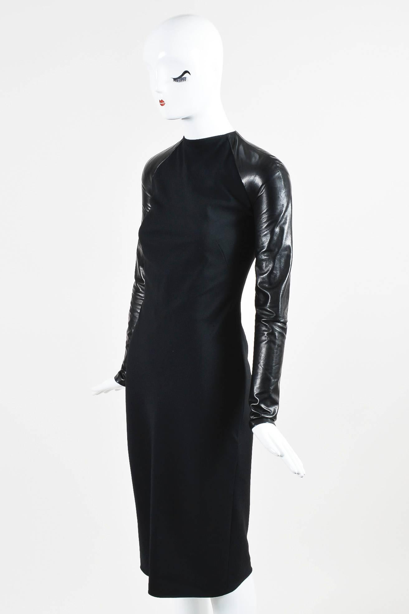 Retails at $5295. This sleek dress off the fall 2012 runway can effortlessly transition from day to evening. Woven wool textile. Leather long sleeves with zip closure. High neckline. Interior mesh panel with corset boning inside body. Open back with