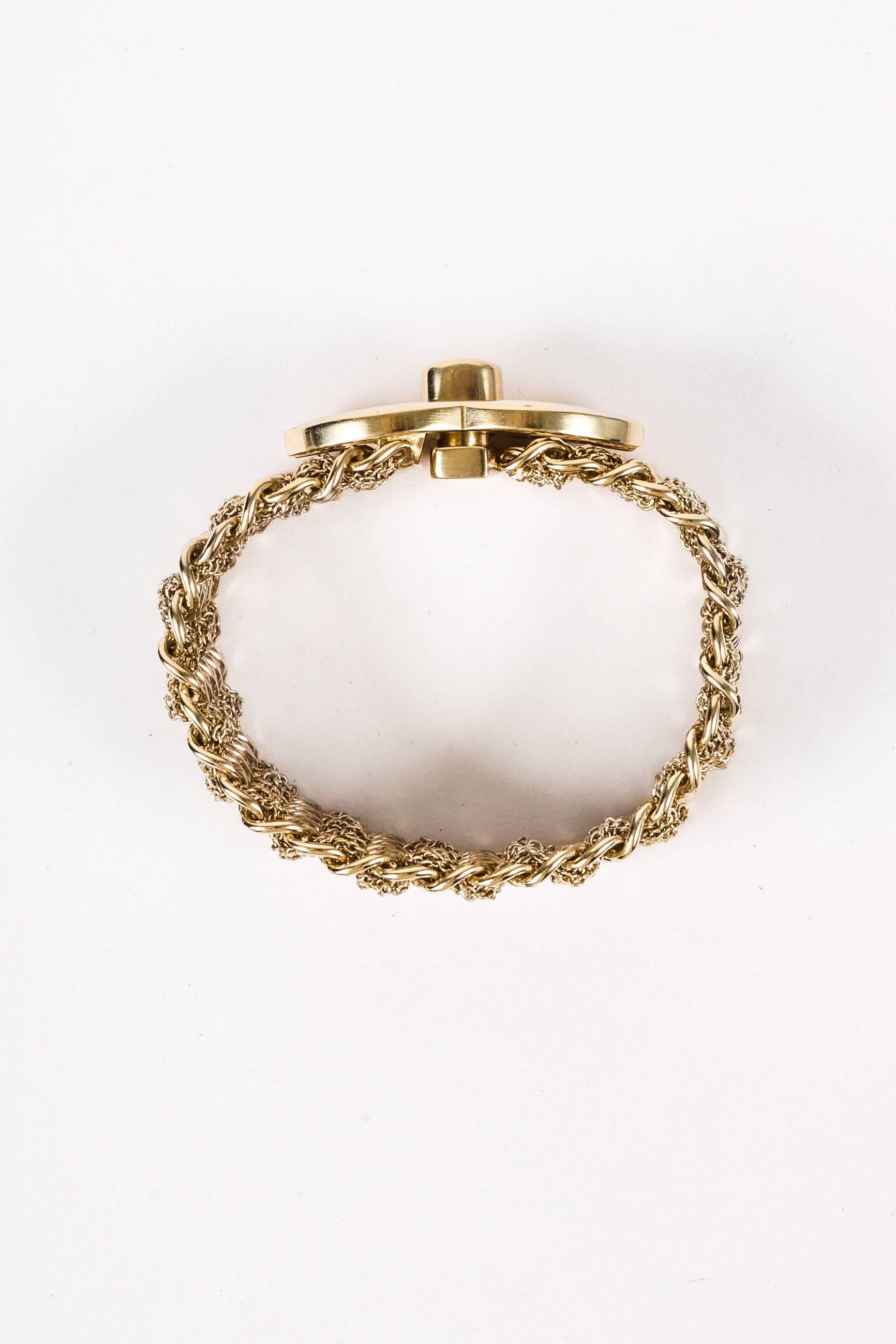 Comes in dust bag. Circa 2012, this versatile chain bracelet features gold-tone links with daintier strands woven between each. Oversized 'CC' logo turn lock.

Measurements: Total Length 6.875