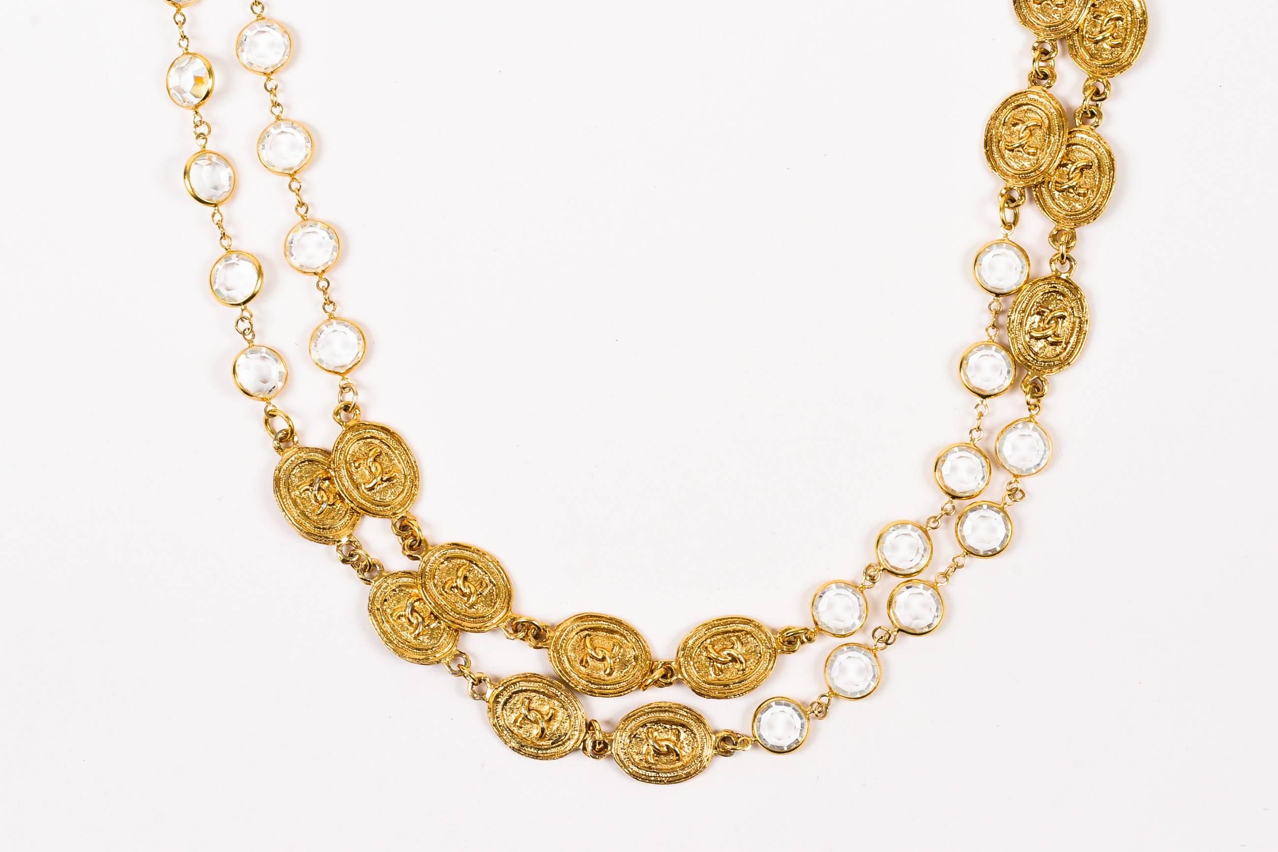 Comes with box. Gorgeous, vintage Chanel necklace. Design circa 1985. This rare collector's item adds an upscale, elegant finishing touch to any look. Rich, gold-tone metal. Oval stations with iconic 'CC' logo. Sparkling bezel set glass crystals.