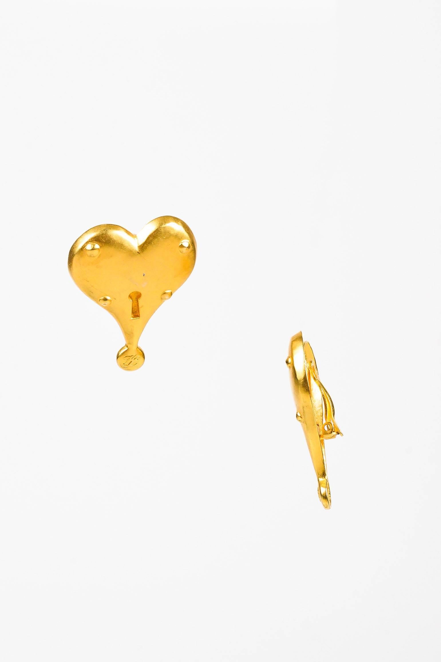 Vintage statement earrings by Karl Lagerfeld. Large matte gold-tone hearts with key hole centers. Clip on backs.

Measurements: Total Height 1.875