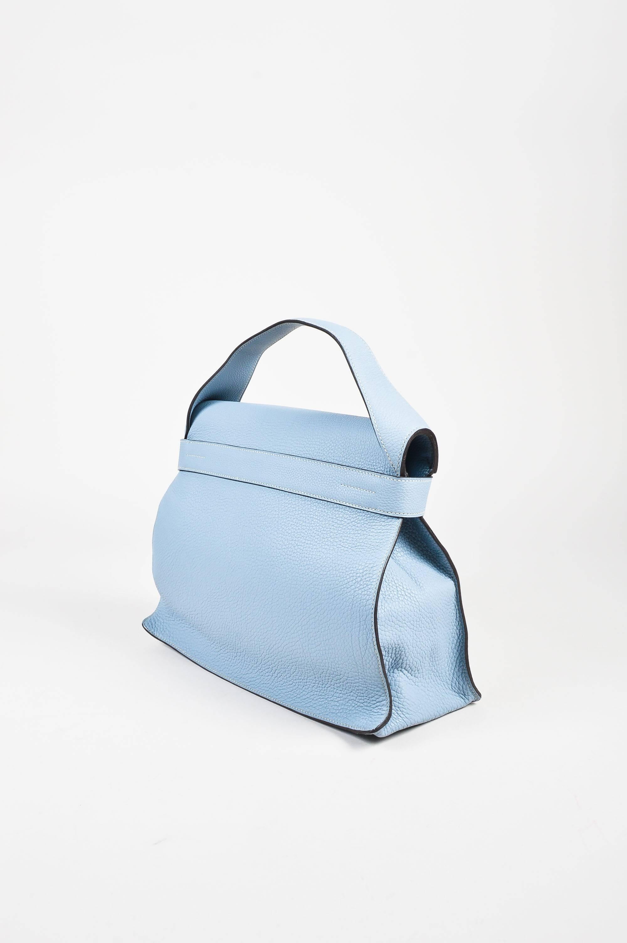 Retails at $7700. Circa 2012 this gorgeous "Etribelt" bag is constructed of blue Togo leather. Single top strap and front strap with palladium buckle closure.

Interior features: Flat pocket

Additional measurements: Handle Length