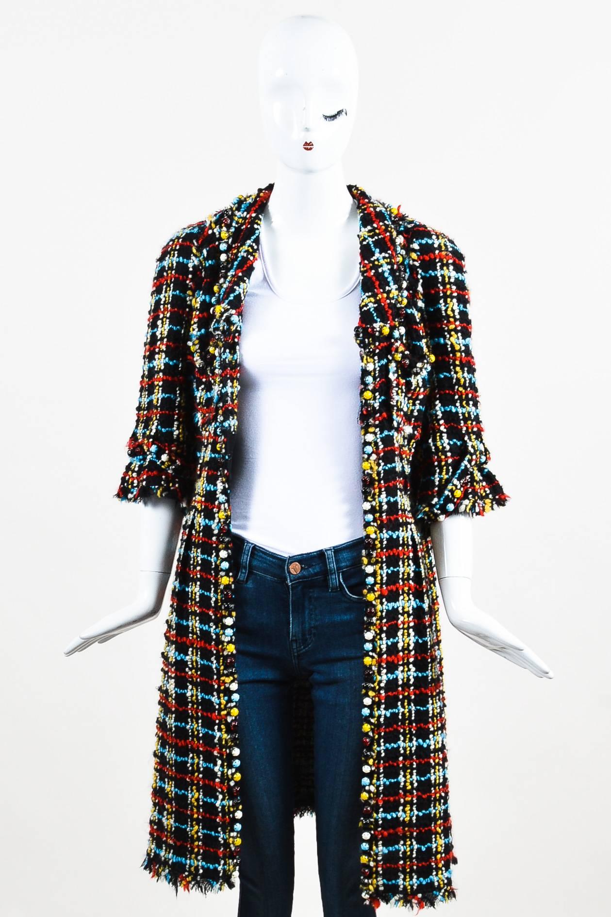 A bright and fun coat by Chanel in a vibrant colorway. This chic topper features a chunky tweed material with pops of red, blue, and yellow. Bubble beads around the collar, cuffs, and front opening in matching hues. Hook-and-eye front closure around