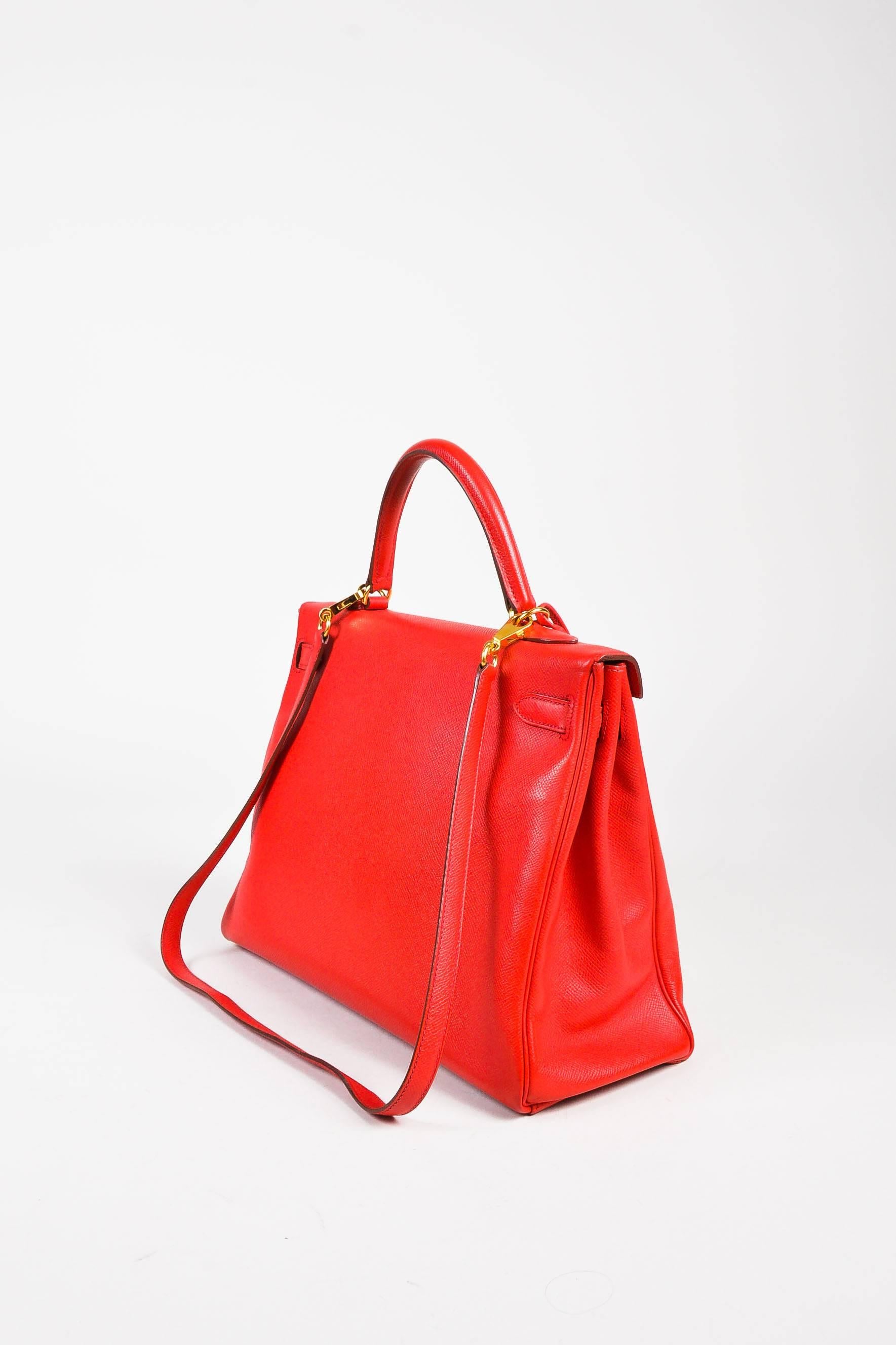 Size: 35 cm
Color: Geranium Red
Made In: France
Fabric Content: Epsom Leather

Item Specifics & Details: Circa 2009 iconic Hermes 32 cm size "Kelly" bag comes in right "geranium" red Epsom pebbled leather with gold-tone