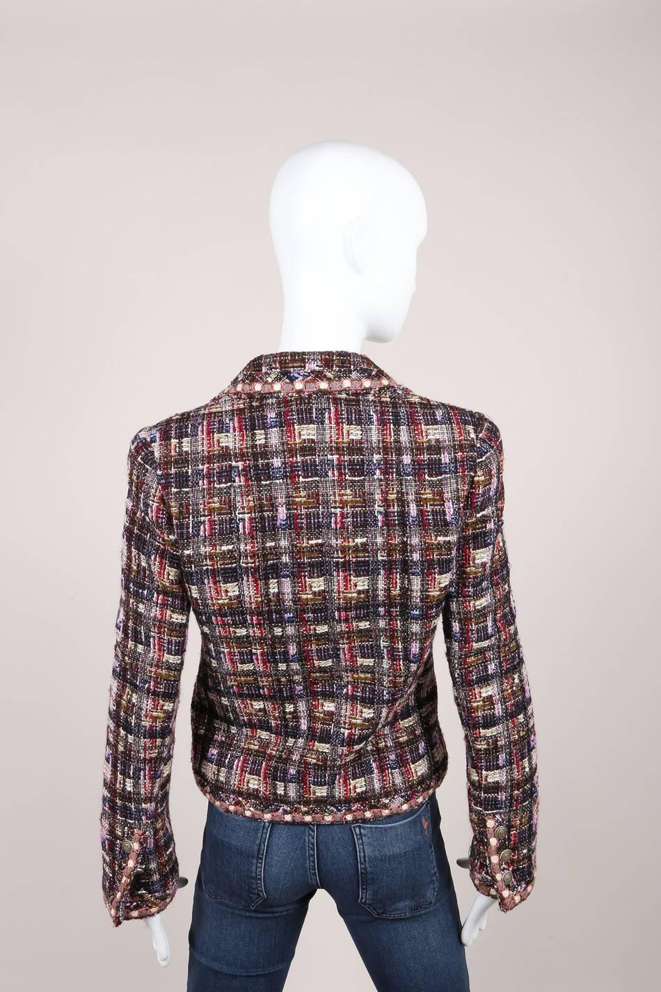 From the 2005 Fall collection. Fitted, tailored-cut blazer jacket. Constructed of signature Chanel tweed knit in multicolor checkered pattern. Notch collar. Long sleeves with button fastening. Front button fastening . Buttons features silver-tone