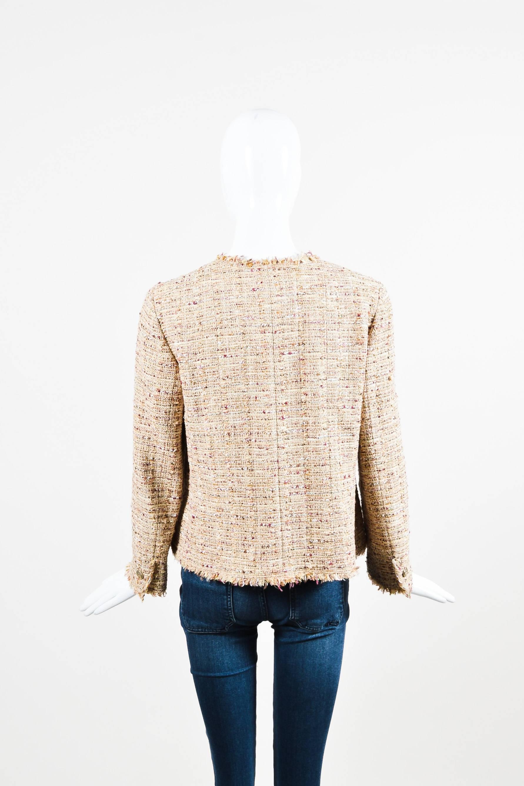 Classic Chanel tweed jacket. Multicolor weaving throughout with hints of iridescent threading. Fringe trimmings. Hammered gold-tone coated buttons. Long sleeves with button closure. Jewel neckline. Front patch pockets with button closure. Buttons at
