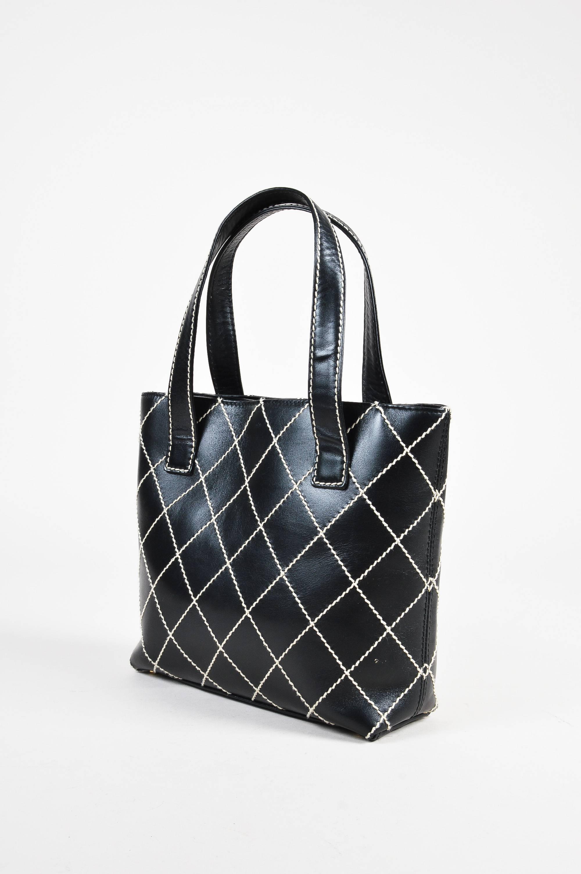 This chic tote is perfect to pair with a black suit for the office. Comes with dust bag. Black leather 