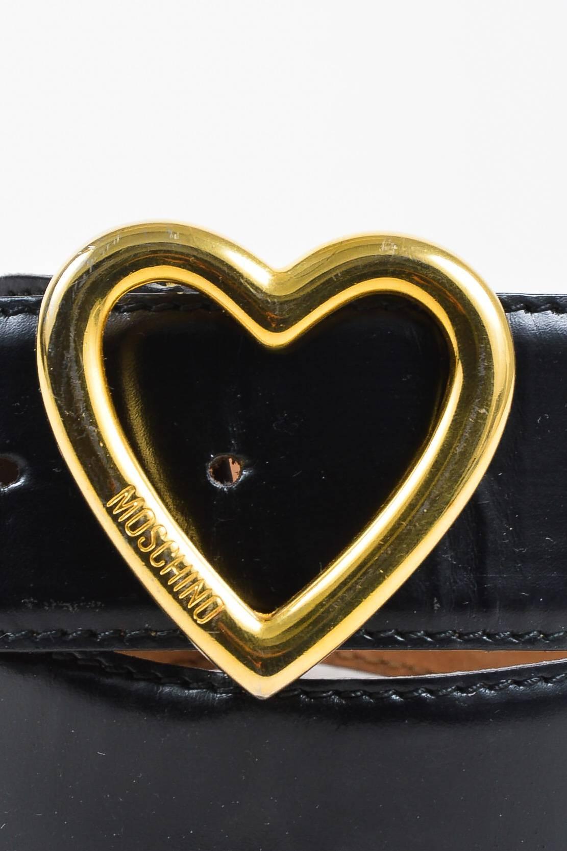 Released around the late 1980's to early 1990's, this vintage belt features a golden metallic heart-shaped buckle, glossy leather, and a wide body. Wear over a voluminous jumpsuit to complete the look.

Size	
40 (IT), 2-4 (US)
US Size
