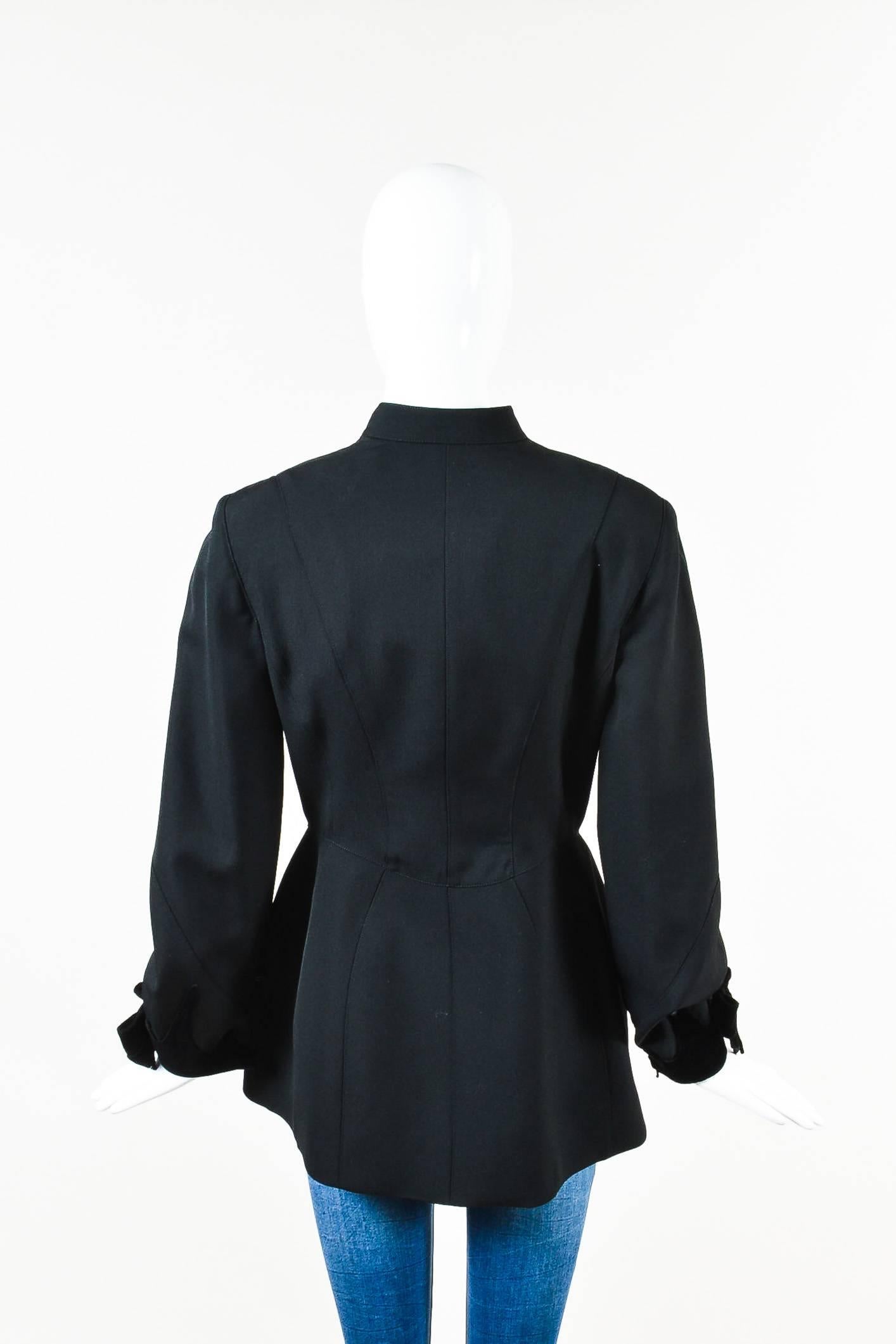 Vintage Thierry Mugler black wool crepe jacket featuring velvet accents at center front and sleeve openings. Snap front closure. Lined.