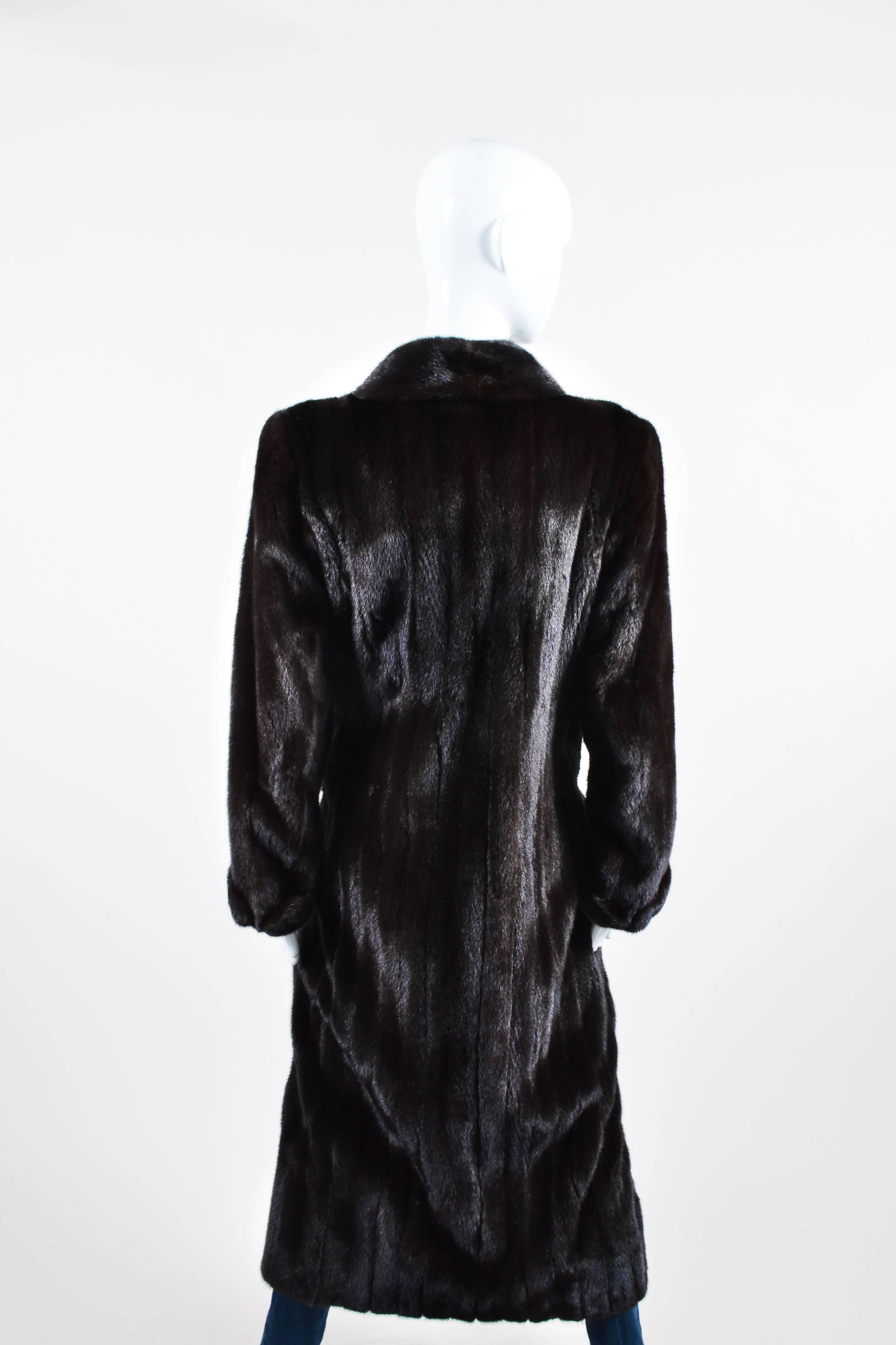 Dark brown mink fur coat. Long sleeves. Shawl collar. Slit pockets. Light shoulder padding. Interior pocket. Single button closure. Lined.

Size: Unknown, no sizing information provided. Refer to measurements.

Additional measurements: Sleeve