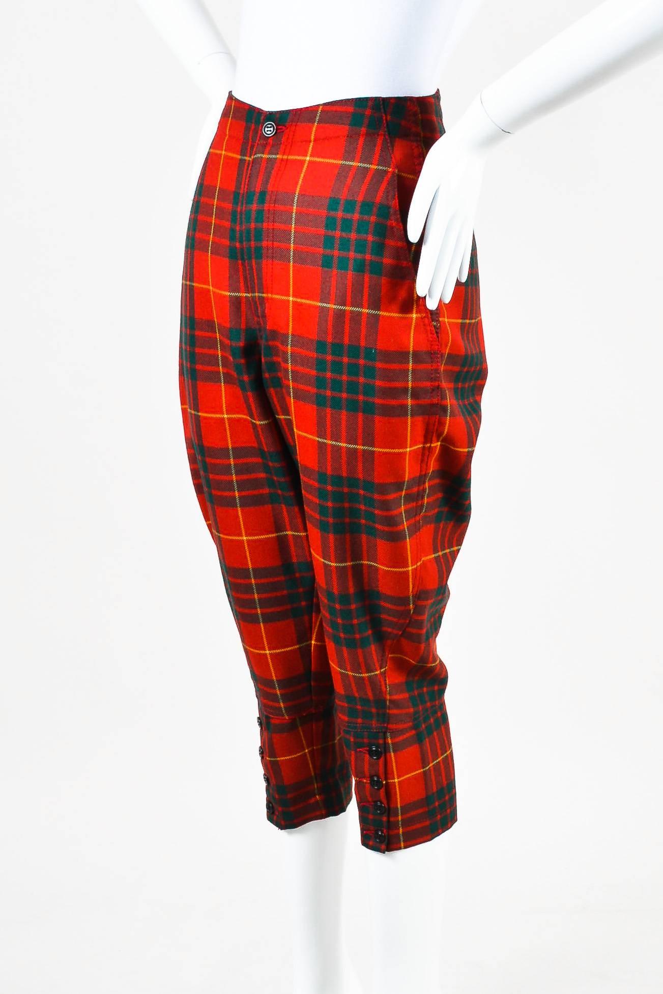 Red, green, and yellow plaid print capri pants. Constructed of wool. Angled pockets. Center-fly fastening.

Measurements
Waist: 28"
Hips: 34.5"
Inseam: 20.5"