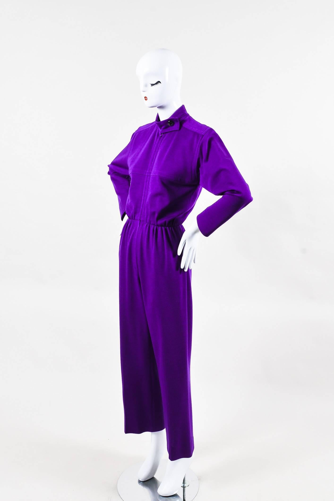 Vintage purple jumpsuit. Appears to be constructed wool. Long sleeves. Concealed front zipper. Long sleeves. Stand collar. Seam pockets. Partially lined.

Additional measurement: Inseam 28.5"