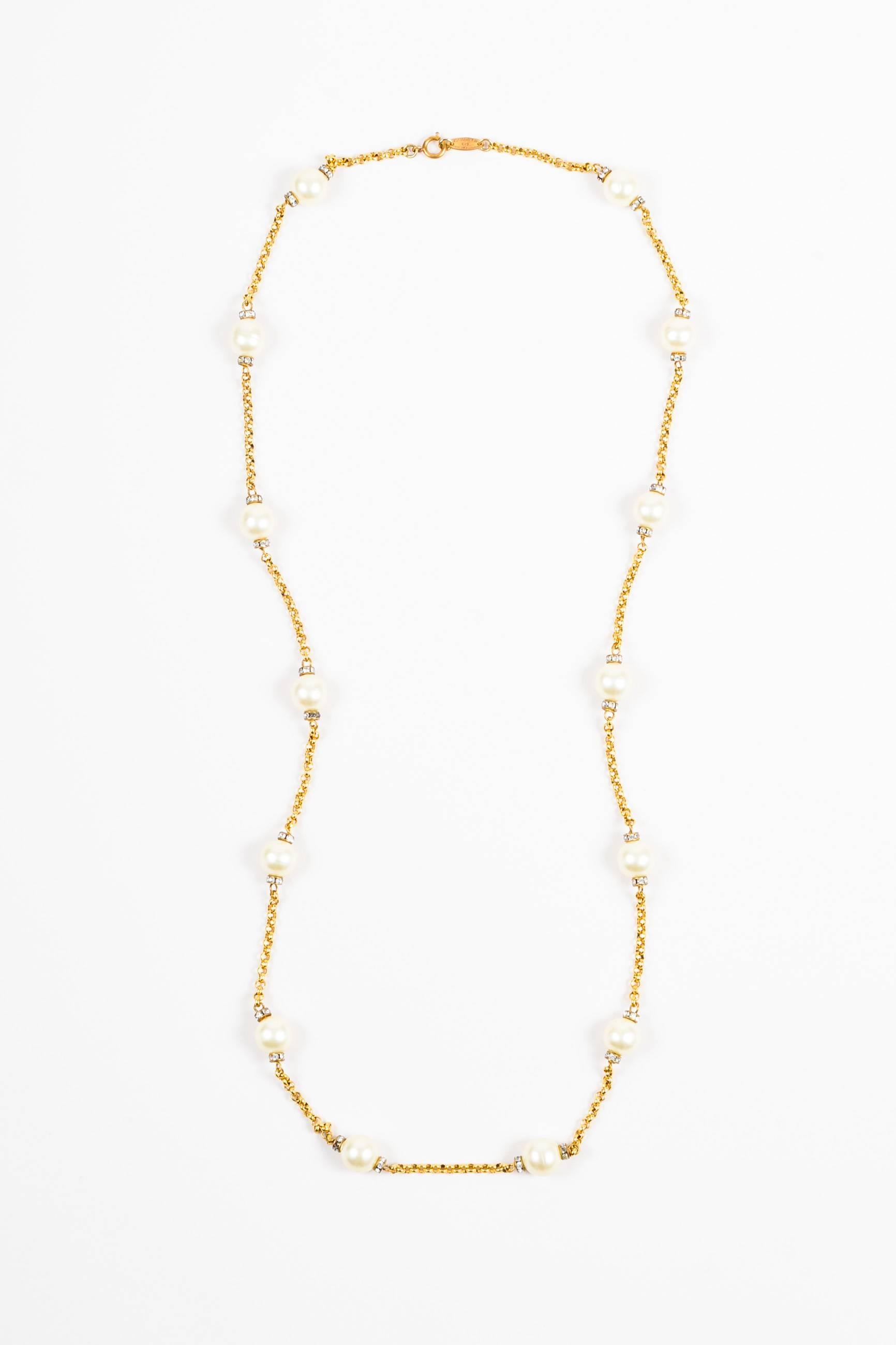 VINTAGE Chanel gold-tone metal strand necklace featuring round faux pearl beading between clear crystal rhinestones. Springring closure. Circa 1980's.

Measurements
Total Length: 36.125