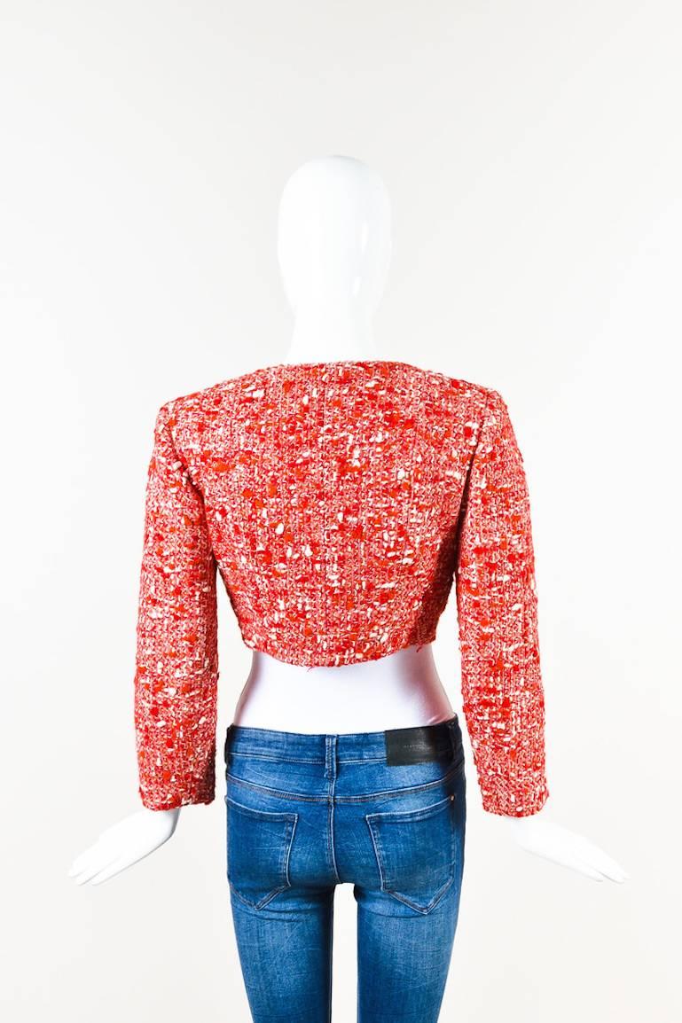 Red, pink, and white double-breasted cropped tweed jacket by Chanel.  Button front closure with red and white 'CC' logo buttons.  Features a flap pocket on right chest with matching button closure.  Fully lined.

Additional measurements: Sleeve