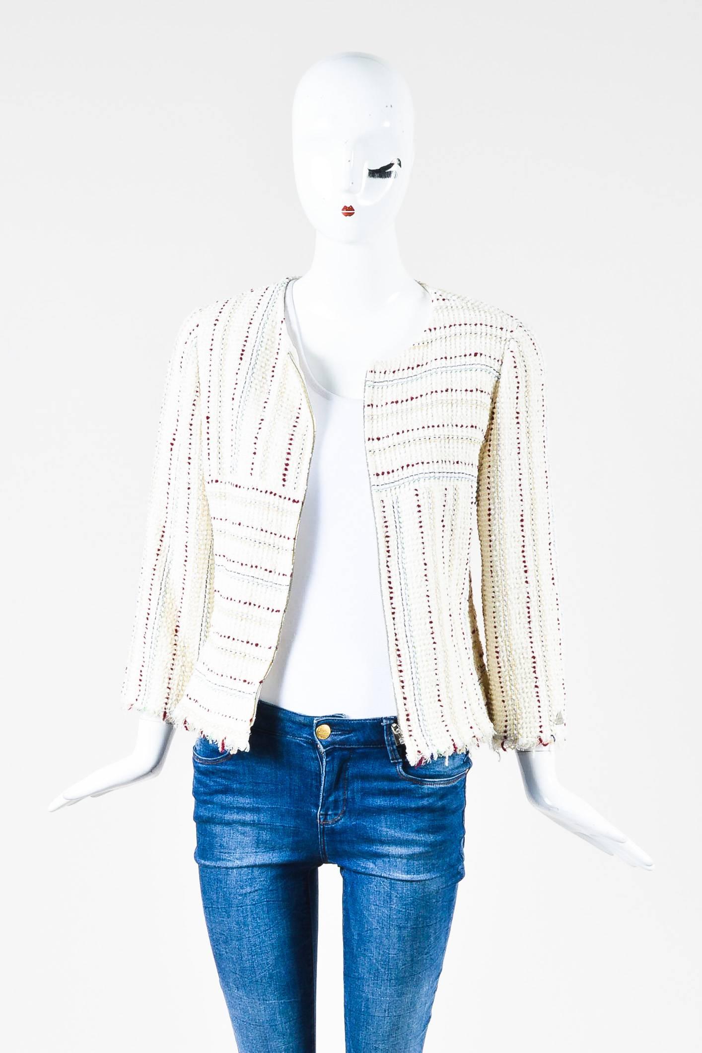 Cream and white knotted boucle jacket by Chanel.  This jacket features multicolored stripes throughout, long sleeves, fringe trim, and silver tone zip front closure.  Fully lined in silk.

Additional measurements: Sleeve Length 19.5