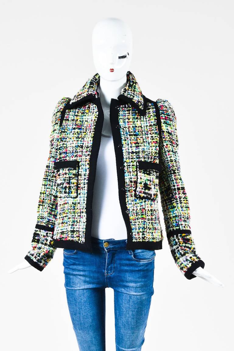 A twist on the classic tweed jacket from the 2007 runway collection. Wool blend construction. Bold multicolor weaving throughout. Felt trimmings. Front patch pockets. Spread collar. Long sleeves. Hits at hips. Hidden front snap button closure.