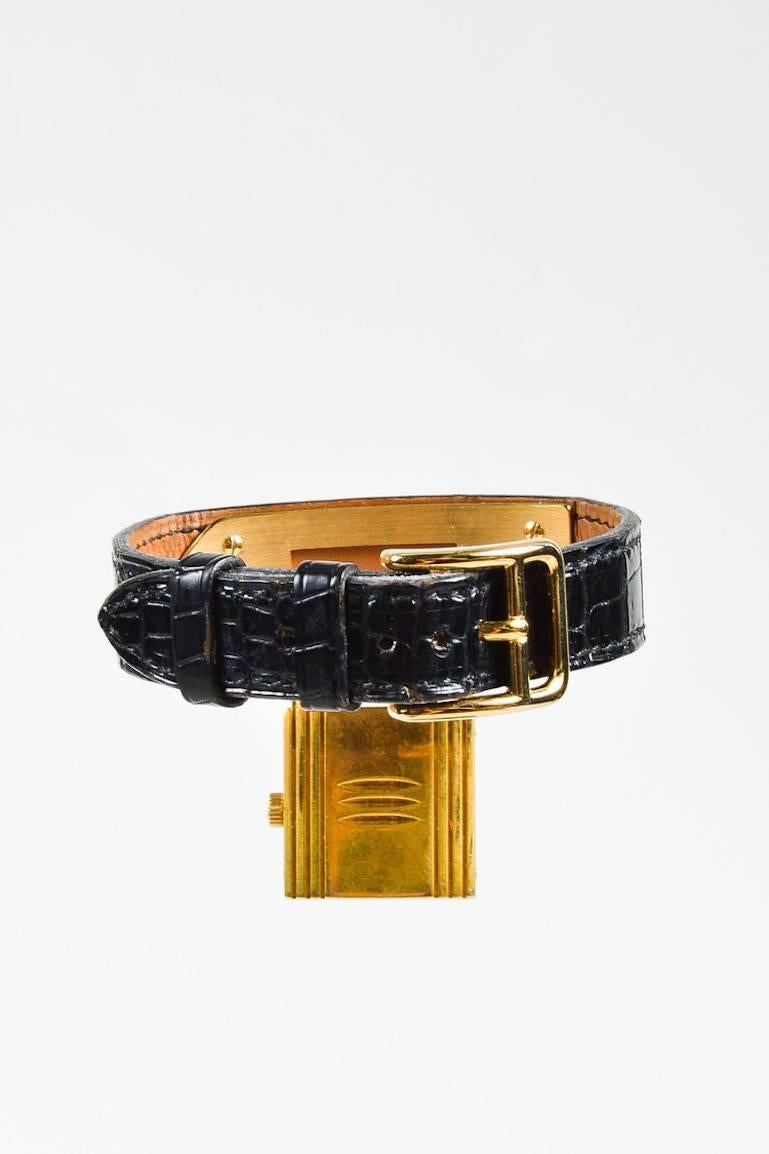 A unique twist on the typical, this vintage "Kelly PM" watch adds a touch of everyday elegance. Luxurious alligator leather band. Gold-plated hardware. Signature "Kelly" plaque with padlock shaped case; padlock watch head may be