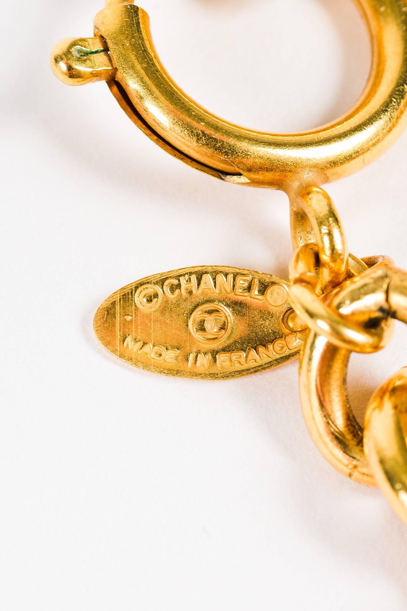 Exude classic Chanel elegance with this vintage statement piece. Gold-tone metal construction. Rolo link chain. Medallion pendants with 'CC' logo and intricate etching. Spring clasp closure.
Vintage, circa early 1980's 

Measurements
Total